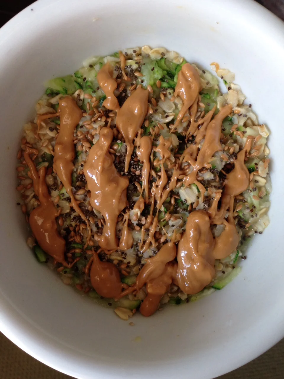 INGREDIENTS: 1/3 CUP of rolled oats 1/4 CUP of shredded zucchini A dash of Cinnamon A dash of Nutmeg (optional) A few drops of Vanilla Extract (optional) 1/2 TBSP Flax Seeds 1/2 TBSP Chia Seeds 1 TBSP any nut butter of your choice (optional) DIRECTIONS: 1. Measure 1/3 cup of rolled oats (I prefer the gluten free oats from Trader Joes) and place in a microwave safe bowl. Fill with equal parts water, if not more. (I usually add a bit more water so it comes out creamier.) 2. Add 1/4 cup of shredded zucchini, cinnamon, nutmeg and vanilla to the oats. 3. Mix and microwave for about 1-1:30 minutes. 4, When it's done, top with chia seeds, flax seeds and peanut butter and enjoy! Feel free to add more water, almond milk, stevia, etc. to make it your own! My recipe: Calories: 263 Protein: 10g Fat: 14g Carbohydrates: 27g Sugar: 2g Sodium: 4mg