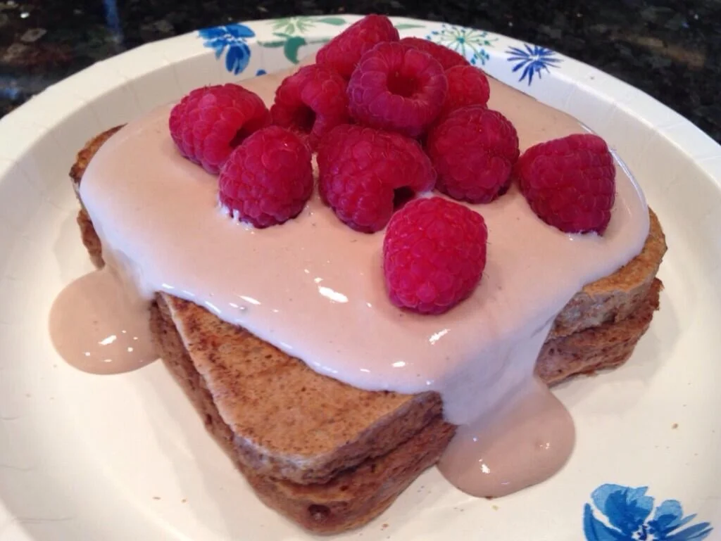 This topping is greek yogurt, almond milk and chocolate protein powder with raspberries. 