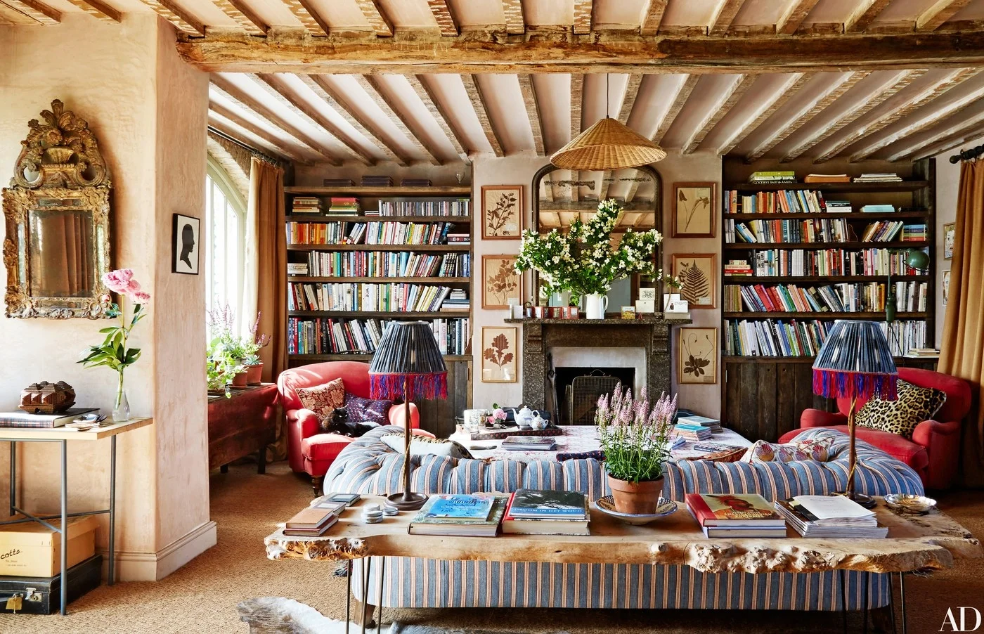 Tons of book, a fireplace, a chesterfield sofa and tons of windows to let view of the rolling hills in... Note to self: the ticking fabric on chesterfield sofa paired with leopard print pillow on red armchairs looks heavenly together. Stripes and animals pattern do work.