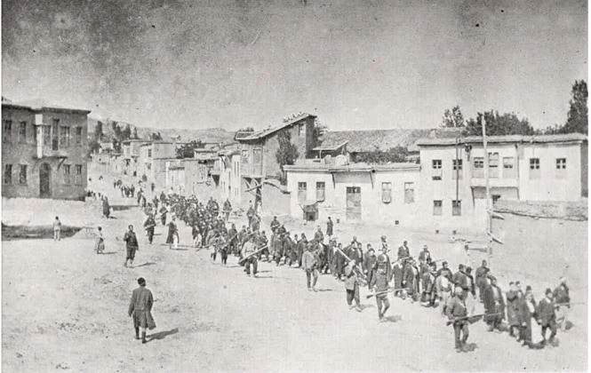 Armenian civilians were marched by Ottoman soldiers to a prison in Mezzireh (now Elazig) in April 1915. Photo licensed through Wikimedia Commons.  