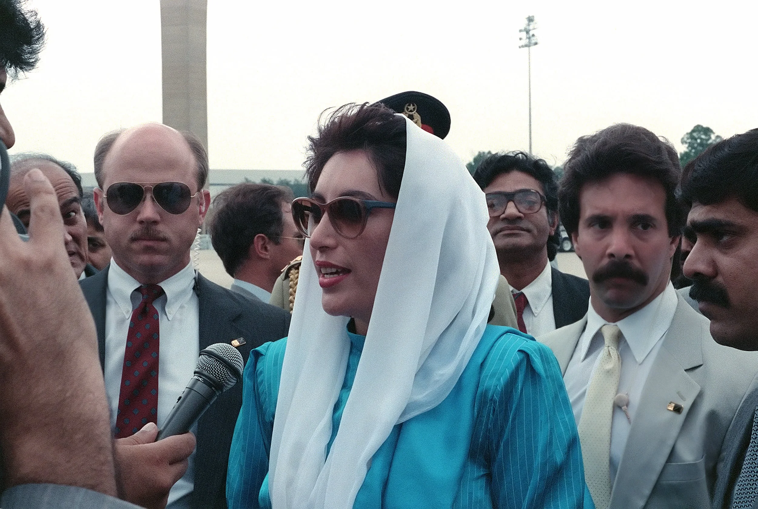 Benazir Bhutto, the Prime Minister of Pakistan, speaks to the press upon her arrival for a state visit at Andrews Air Force Base. photo by gerald b, johnson via wikimedia commons. 