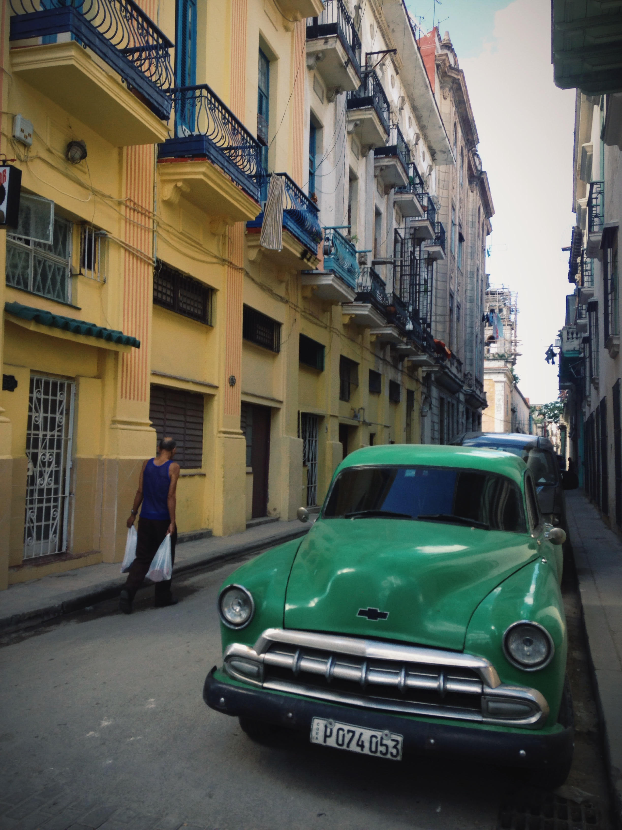 a man walks through havana's streets. photo by meghan dhaliwal for the alignist.