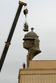 IRAQI CONTRACTORS PREPARE TO REMOVE A STATUE OF SADDAM HUSSEIN'S HEAD FROM THE PRESIDENTIAL PALACE IN BAGHDAD, IRAQ ON DEC. 2, 2003. PHOTO BY PHOTO BY TECH. SGT. JOHN HOUGHTON VIA WIKIMEDIA COMMONS.