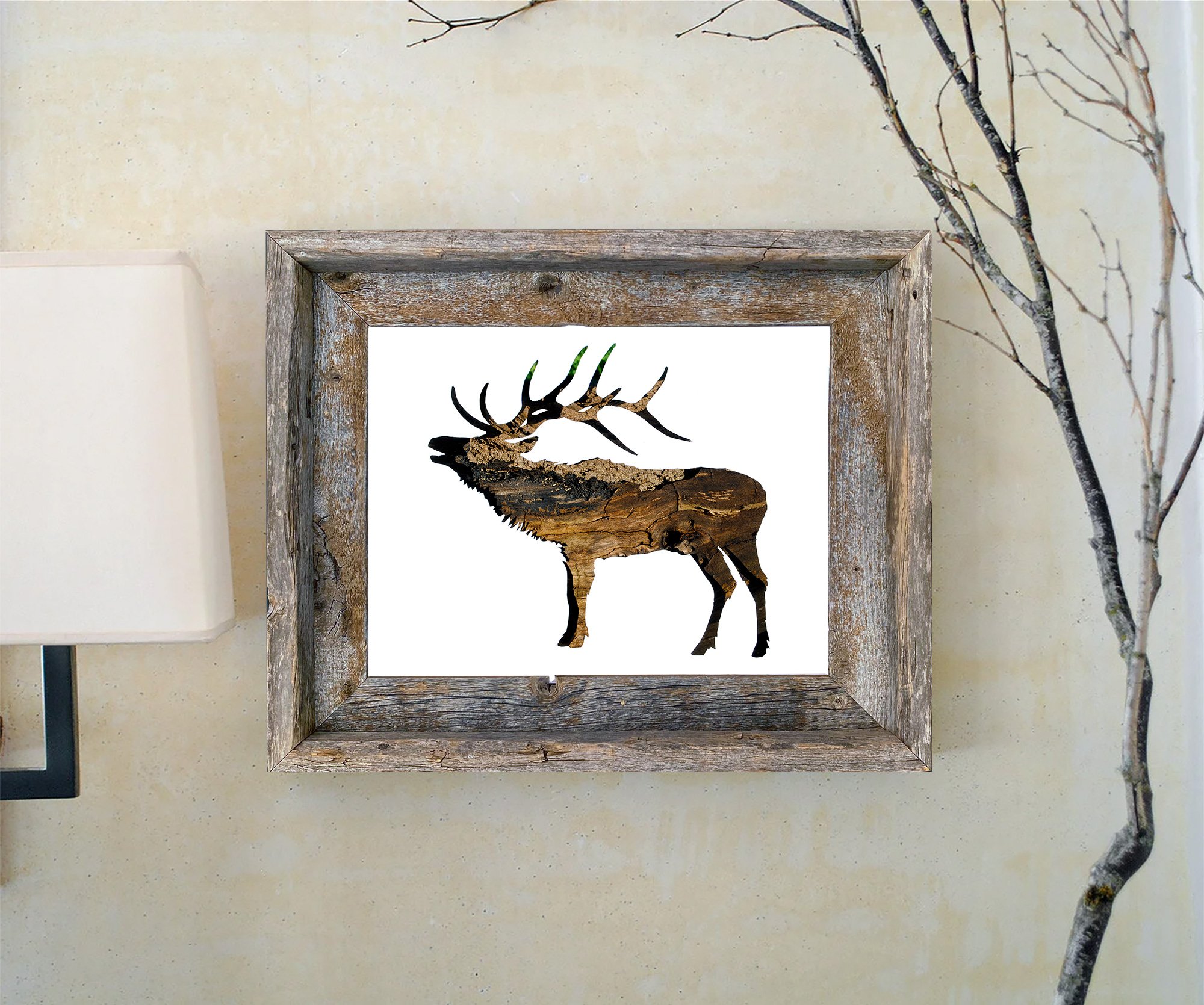 Framed elk bark art print displayed in a rustic wood frame against a light wall with natural branches.