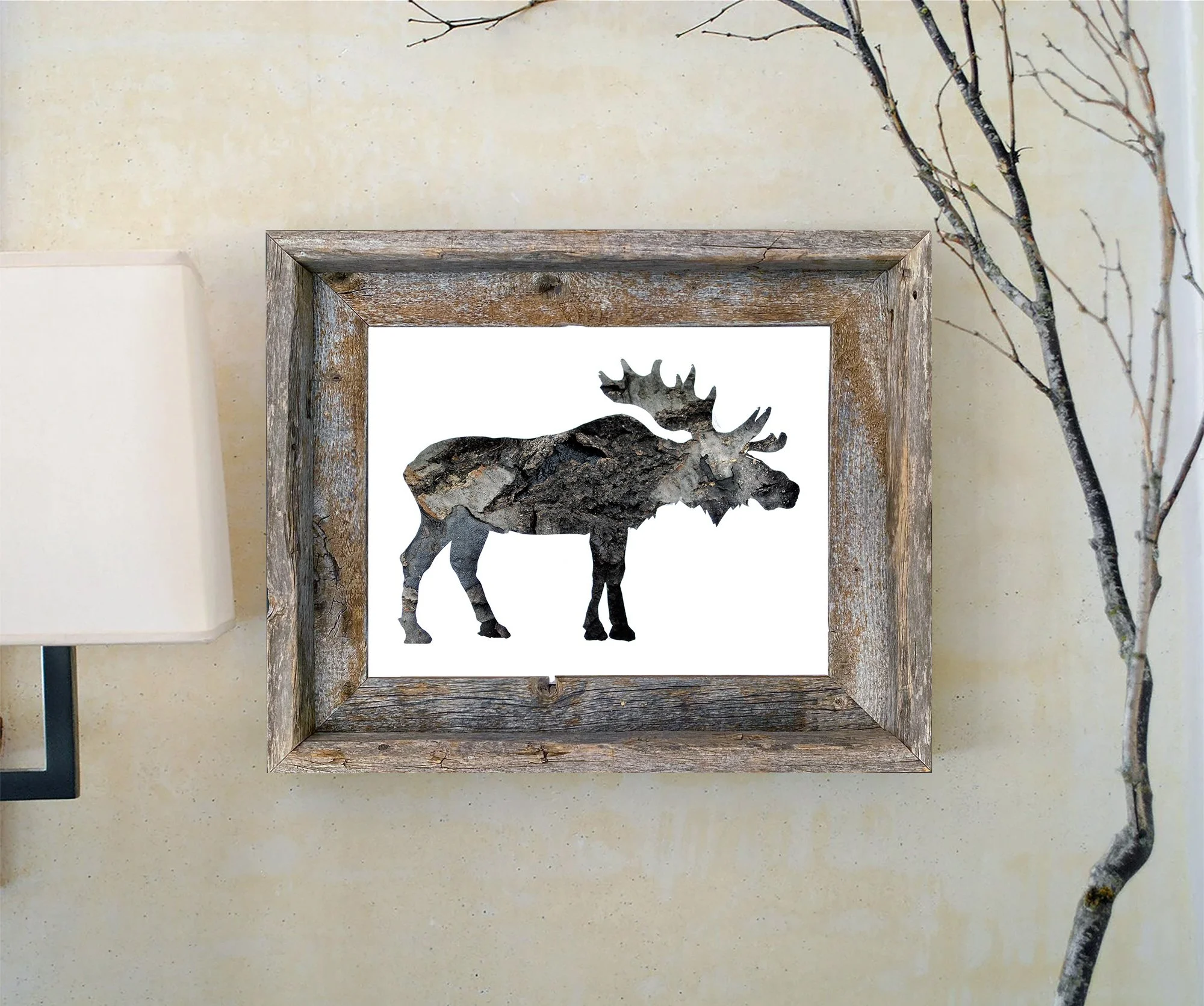 Framed moose bark art print displayed in a rustic wood frame against a light wall with natural branches.