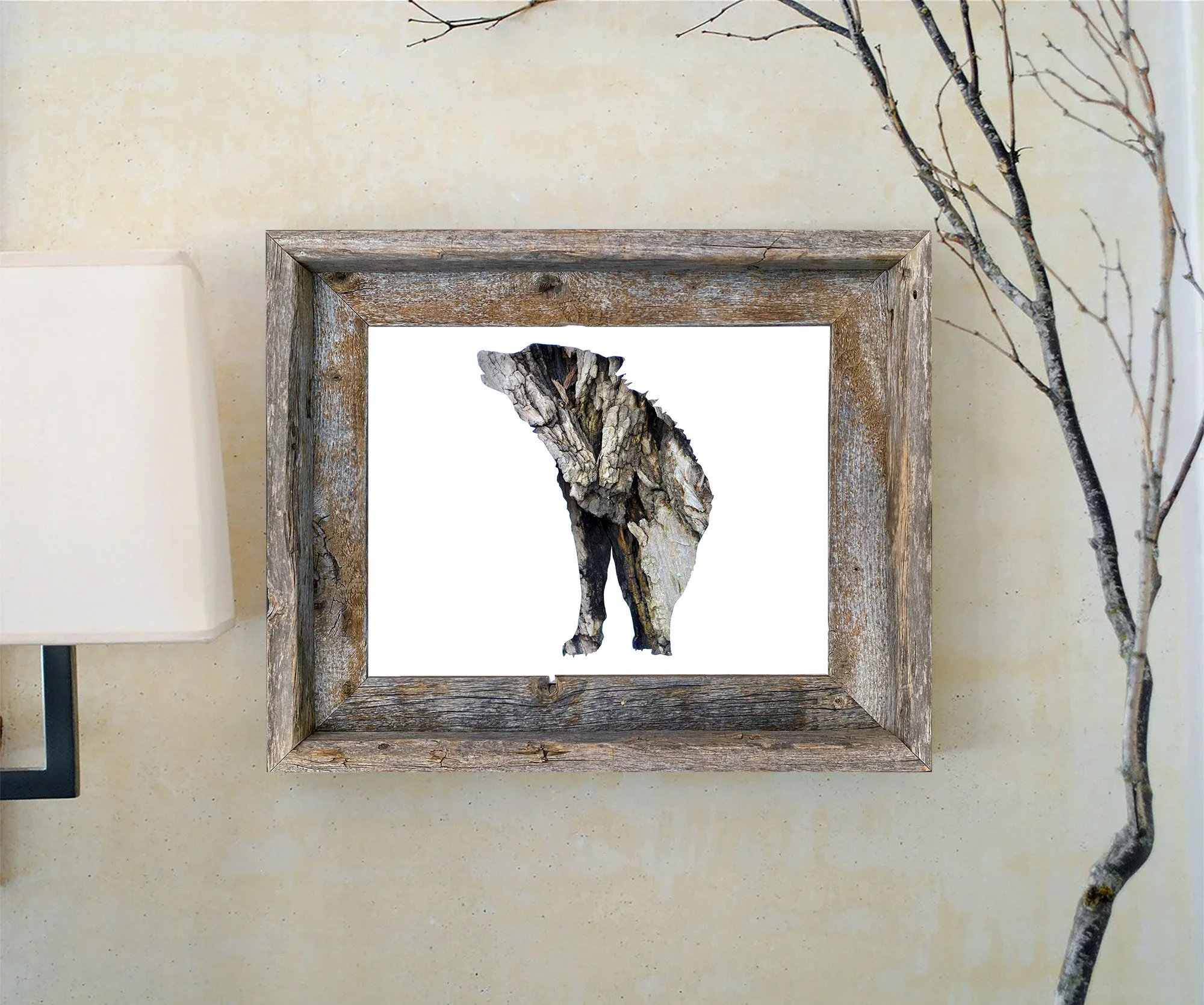 Framed gray wolf bark art print displayed in a rustic wood frame against a light wall with natural branches.