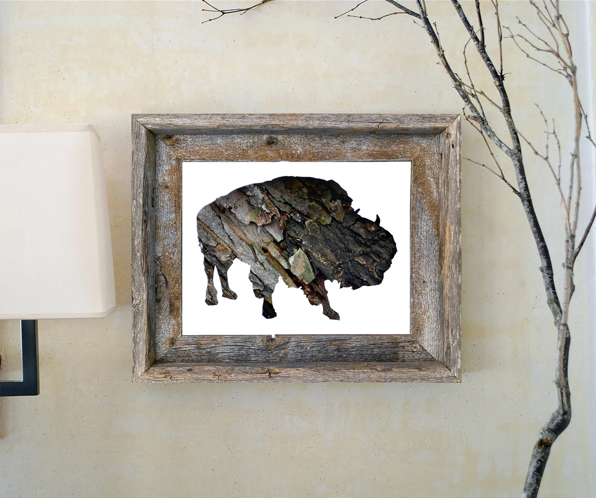 Framed american bison bark art print displayed in a rustic wood frame against a light wall with natural branches.