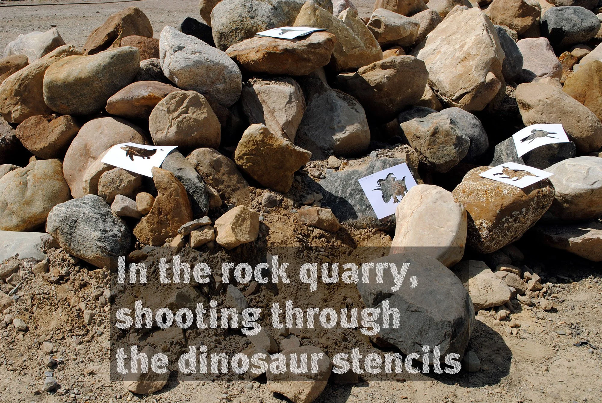 Hand-cut dinosaur stencils photographed among natural stone in an Ohio rock quarry during the creation of the Jurassic Living series.