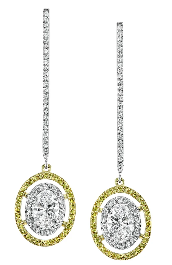 Platinum Diamond Earrings with an Oval Shaped Center Stone and Vivid Yellow Diamonds set in 18 Karat Yellow Gold