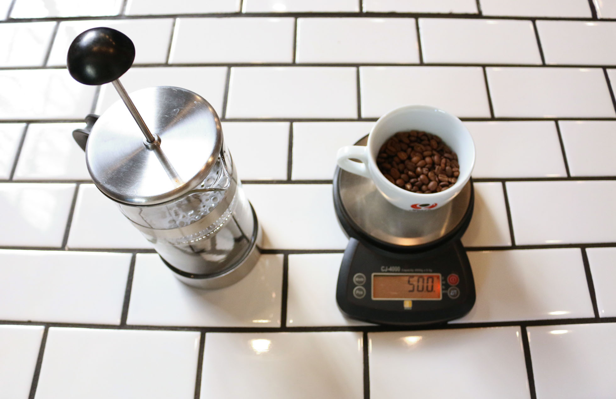 1. Weigh out 50 grams coffee. Heat water to 200°F. Rinse and pre-heat the French Press with the water, then dump out.