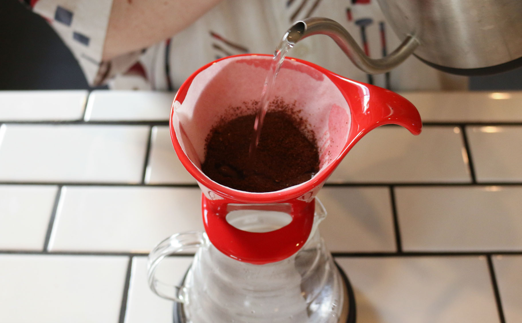 4. Start your timer and begin adding water until the grounds are fully saturated.