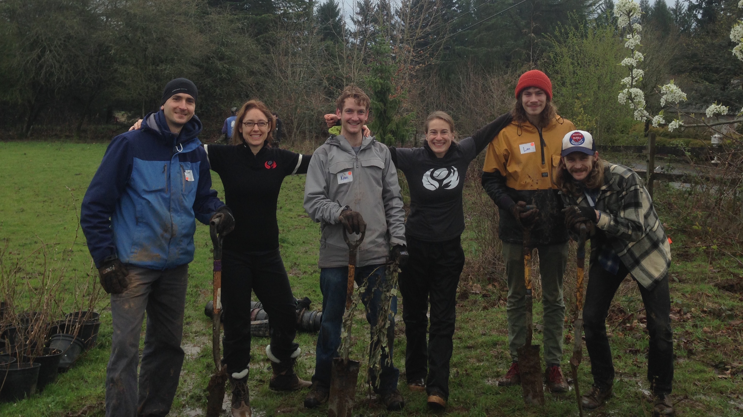 Nossa Familia team members on a staff volunteer day, planting native shrubs on a with Portland non-profit Friends of Trees.
