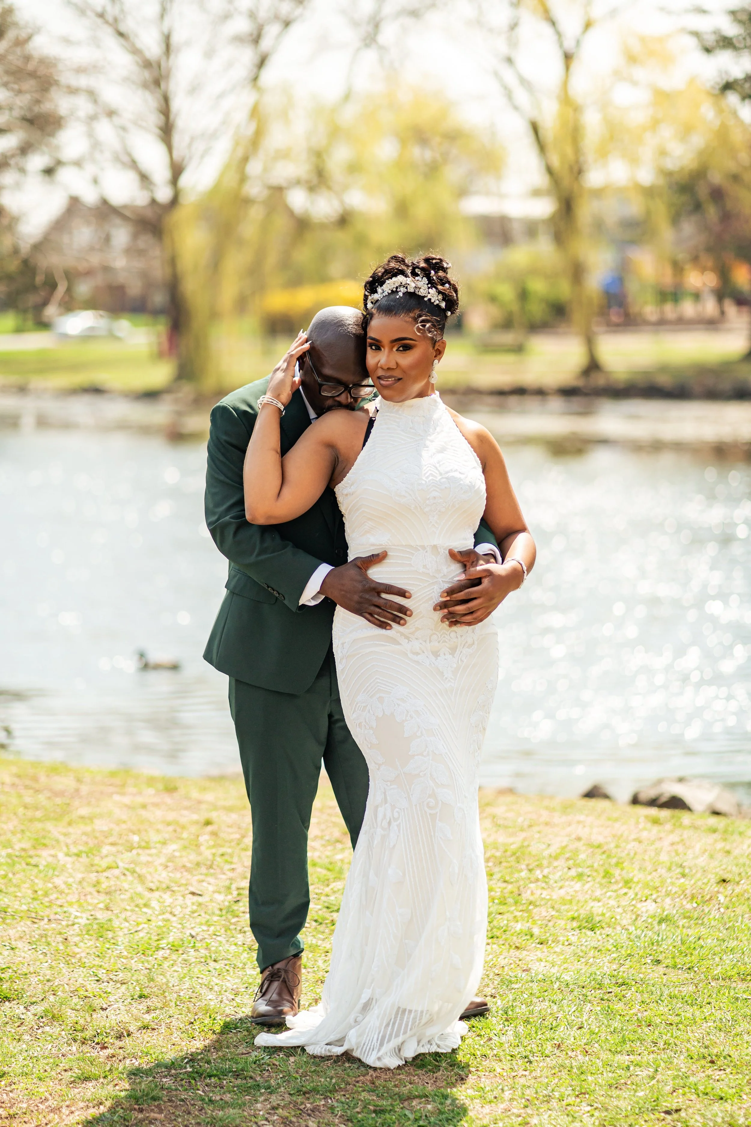Bride and groom posing by the water during their romantic elopement at Mindowaskin Park in Westfield, New Jersey