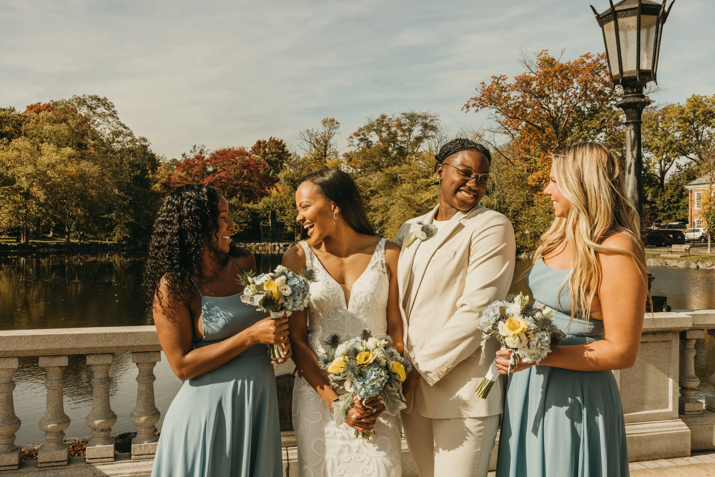 Jaide and Amiaya laughing with their two best friends and witnesses during elopement portraits at Mindowaskin Park in Westfield, NJ.
