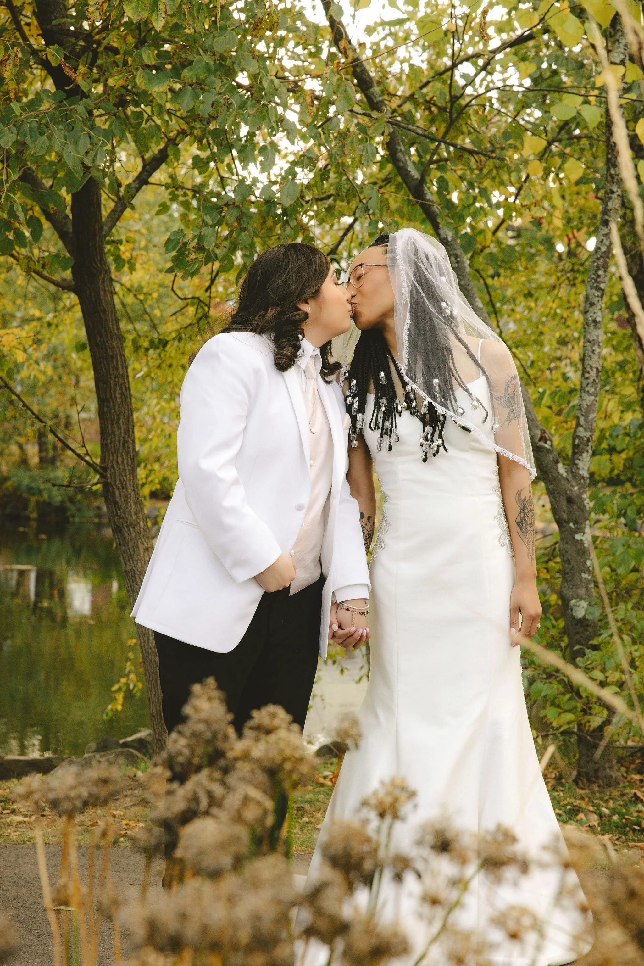 Couple sharing a kiss during an outdoor elopement ceremony in Mercer County, New Jersey, officiated by Aretha Gaskin.