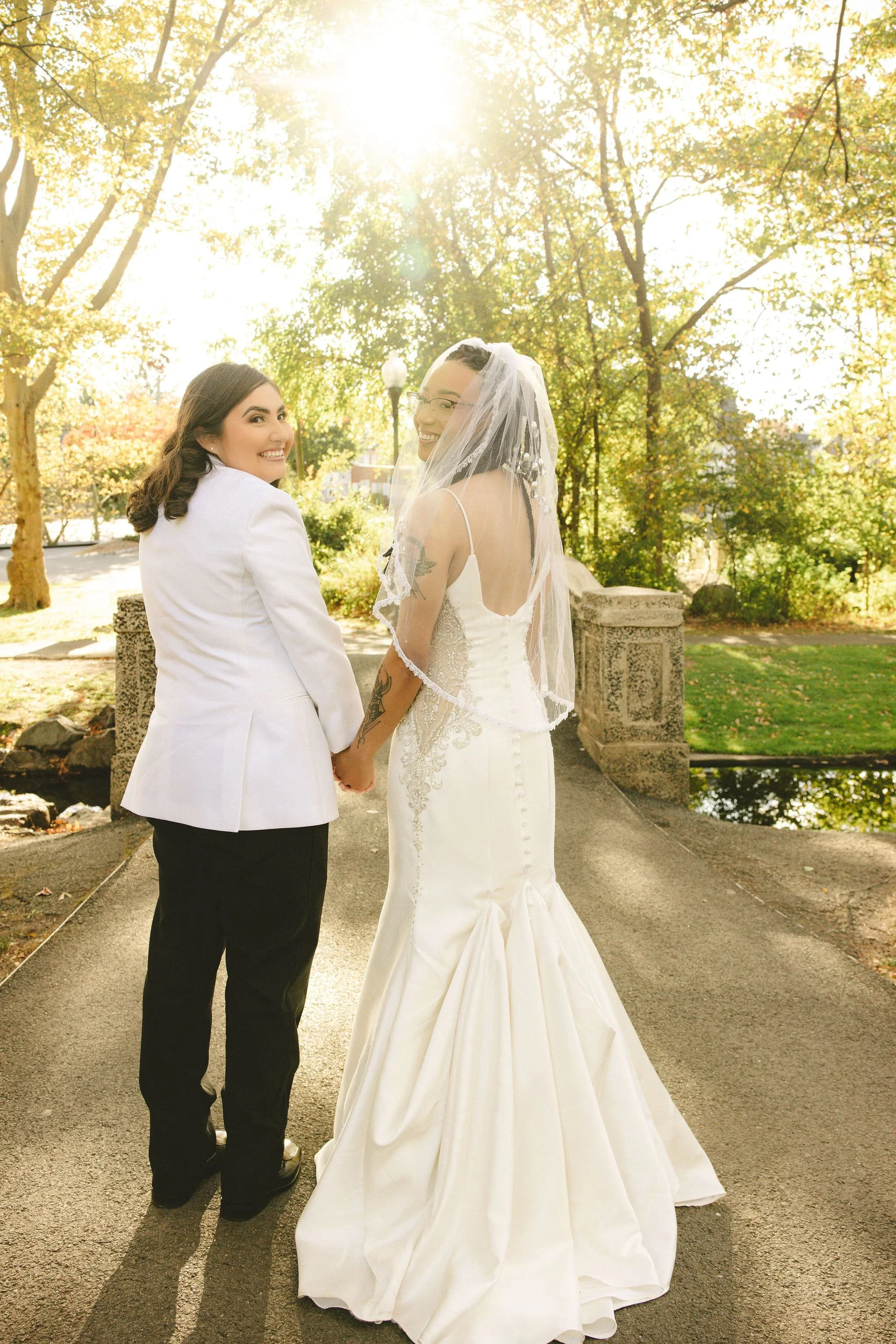 Couple looking back and smiling while walking together after their elopement ceremony in Mercer County, New Jersey