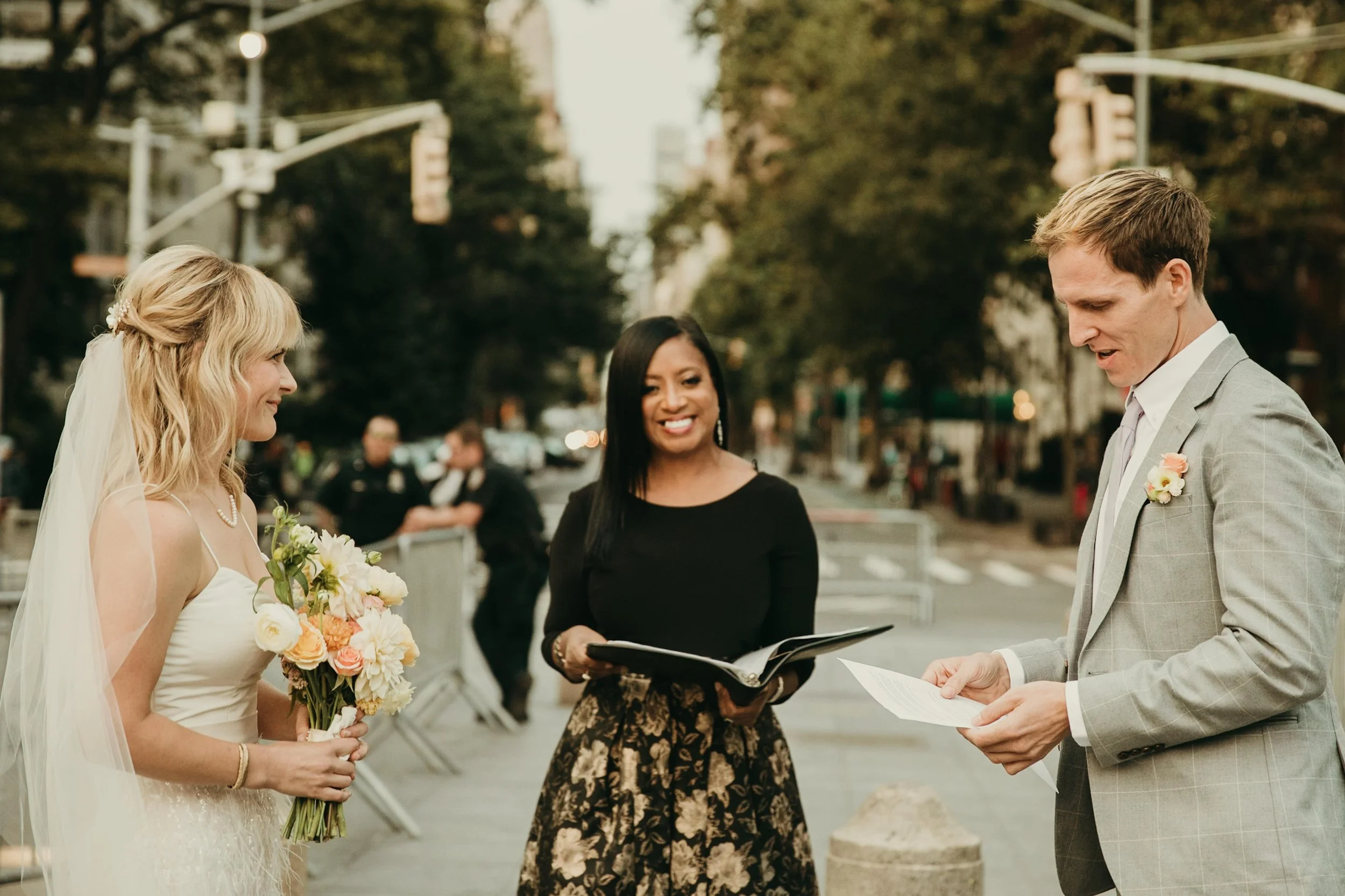 Aretha Gaskin officiating an intimate elopement ceremony, guiding a couple through their vows with warmth and professionalism.