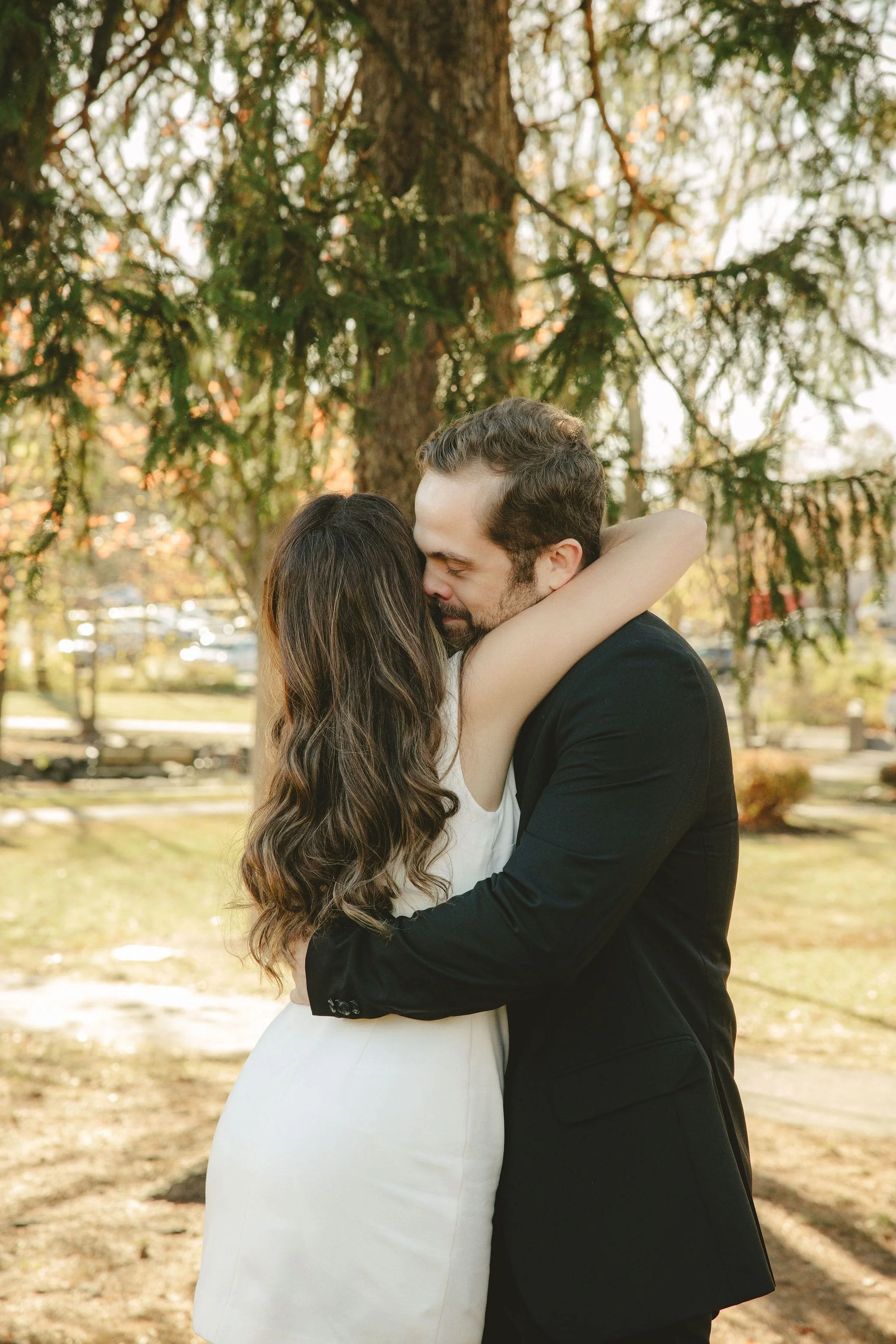 Intimate Monmouth County elopement couple embracing after their ceremony in a peaceful outdoor park setting