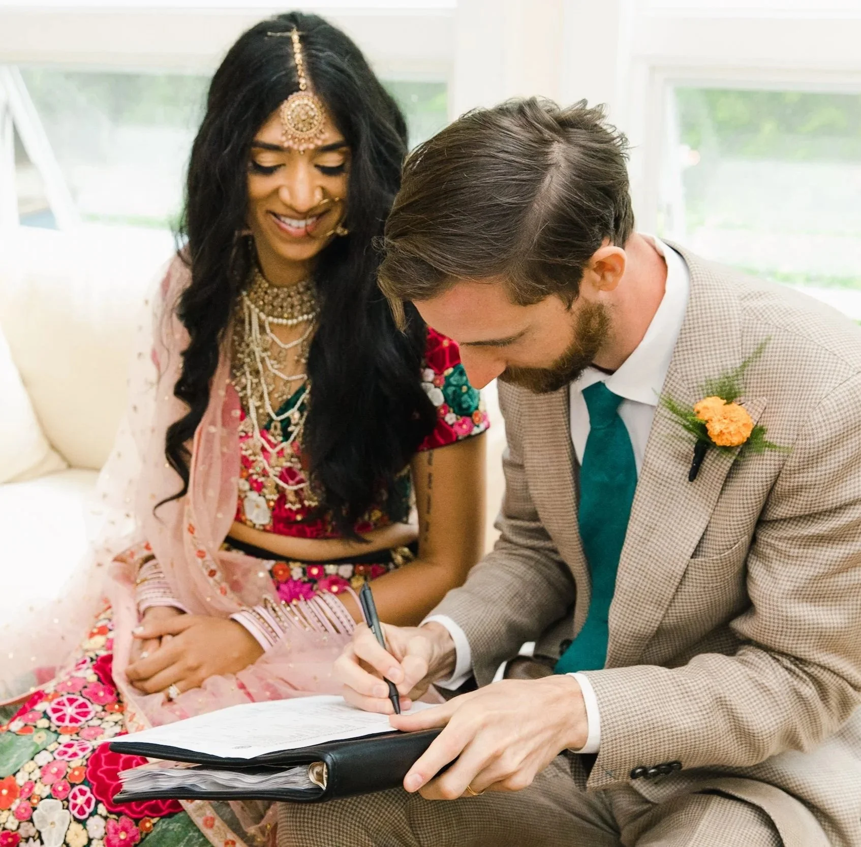 Groom signing the marriage license with his bride after their private elopement ceremony in the Hamptons, New York.