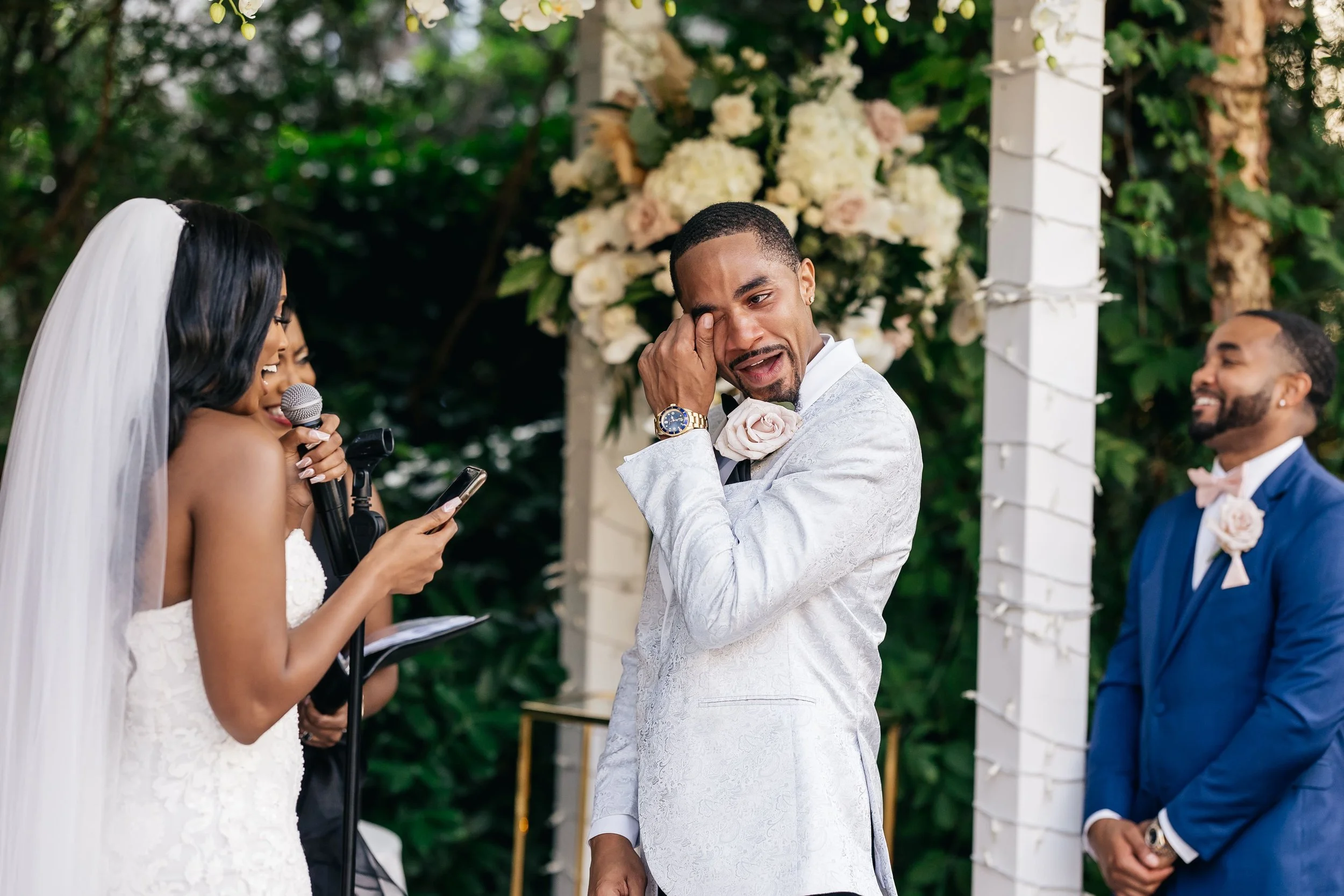 Wedding officiant reading a custom-written ceremony script during vows at The Fox Hollow in Woodbury, New York