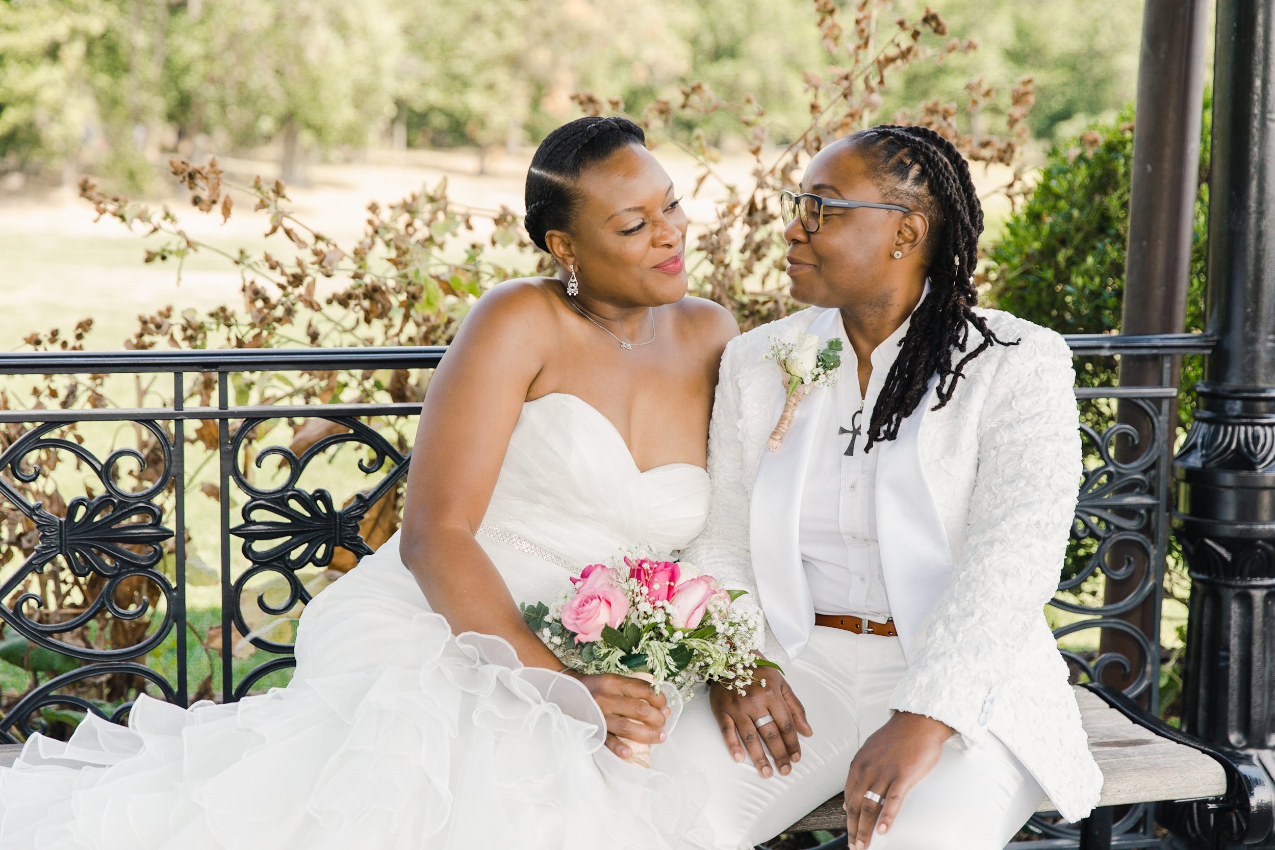 Luciana and Tevonda sitting together as newlyweds after their elopement at Eagle Rock Reservation in West Orange, New Jersey.