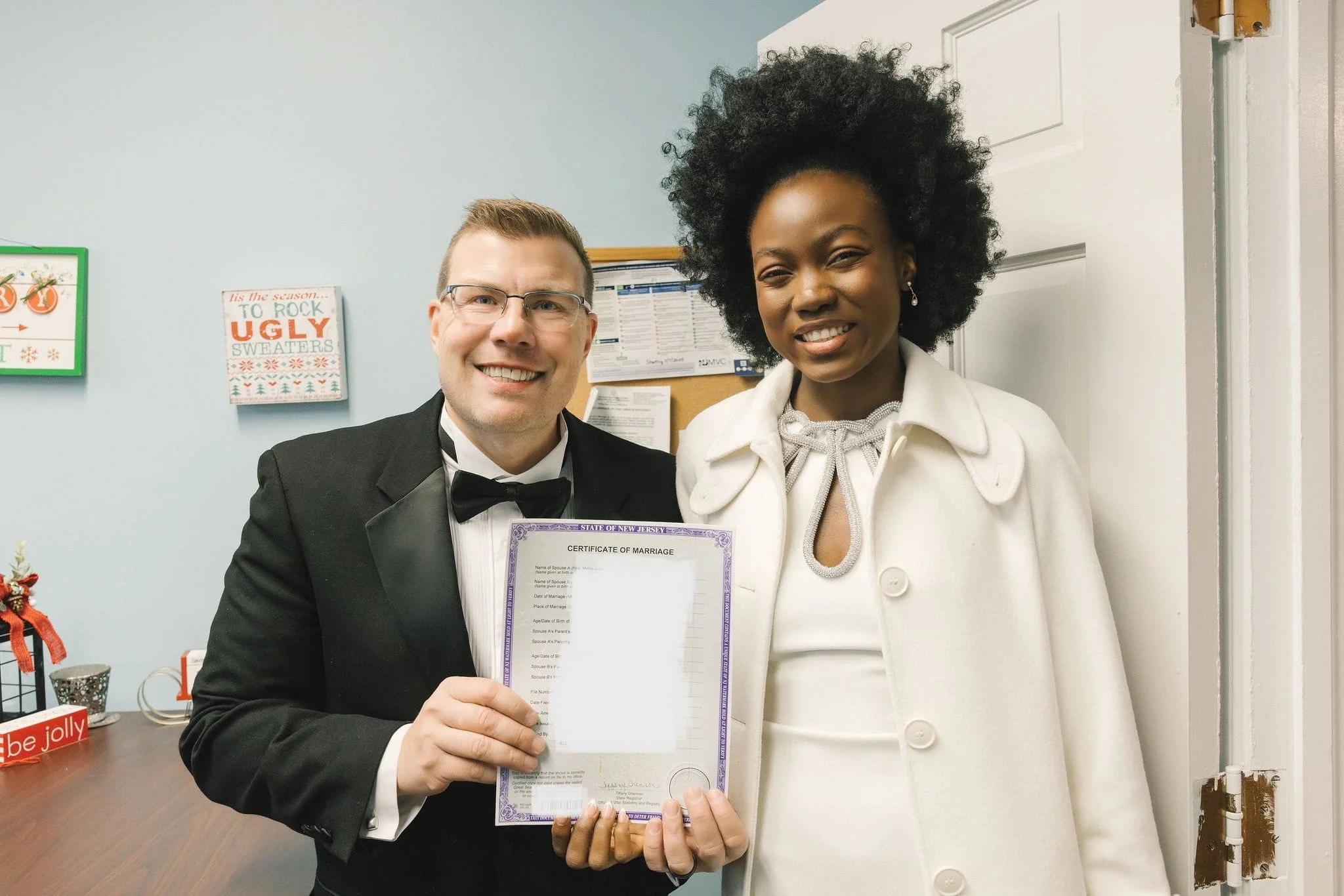 Newlywed couple holding their Certified Marriage Certificate after their wedding in Westfield, New Jersey.
