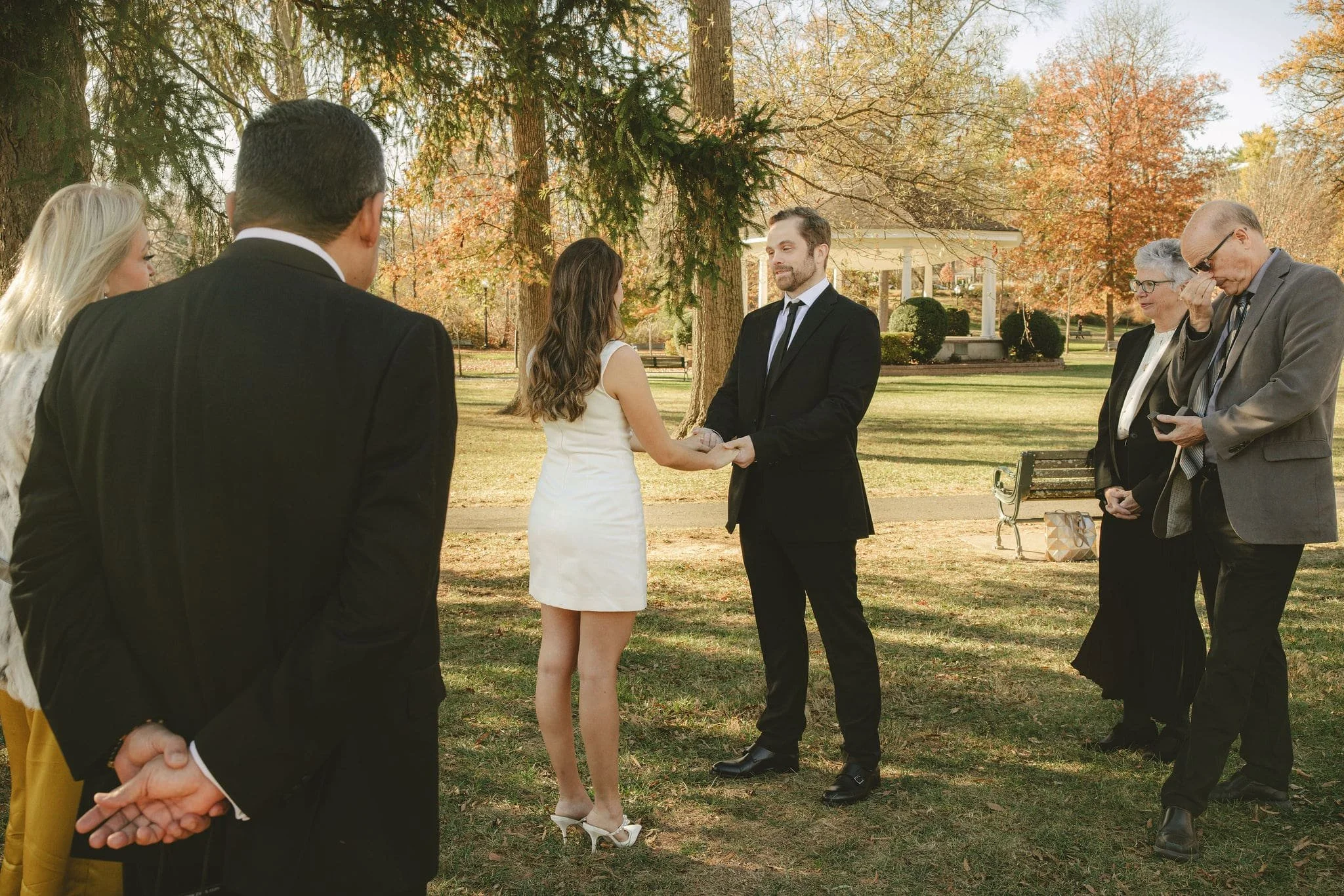 Intimate elopement ceremony in Monmouth County, New Jersey with family members watching as the couple exchanges vows