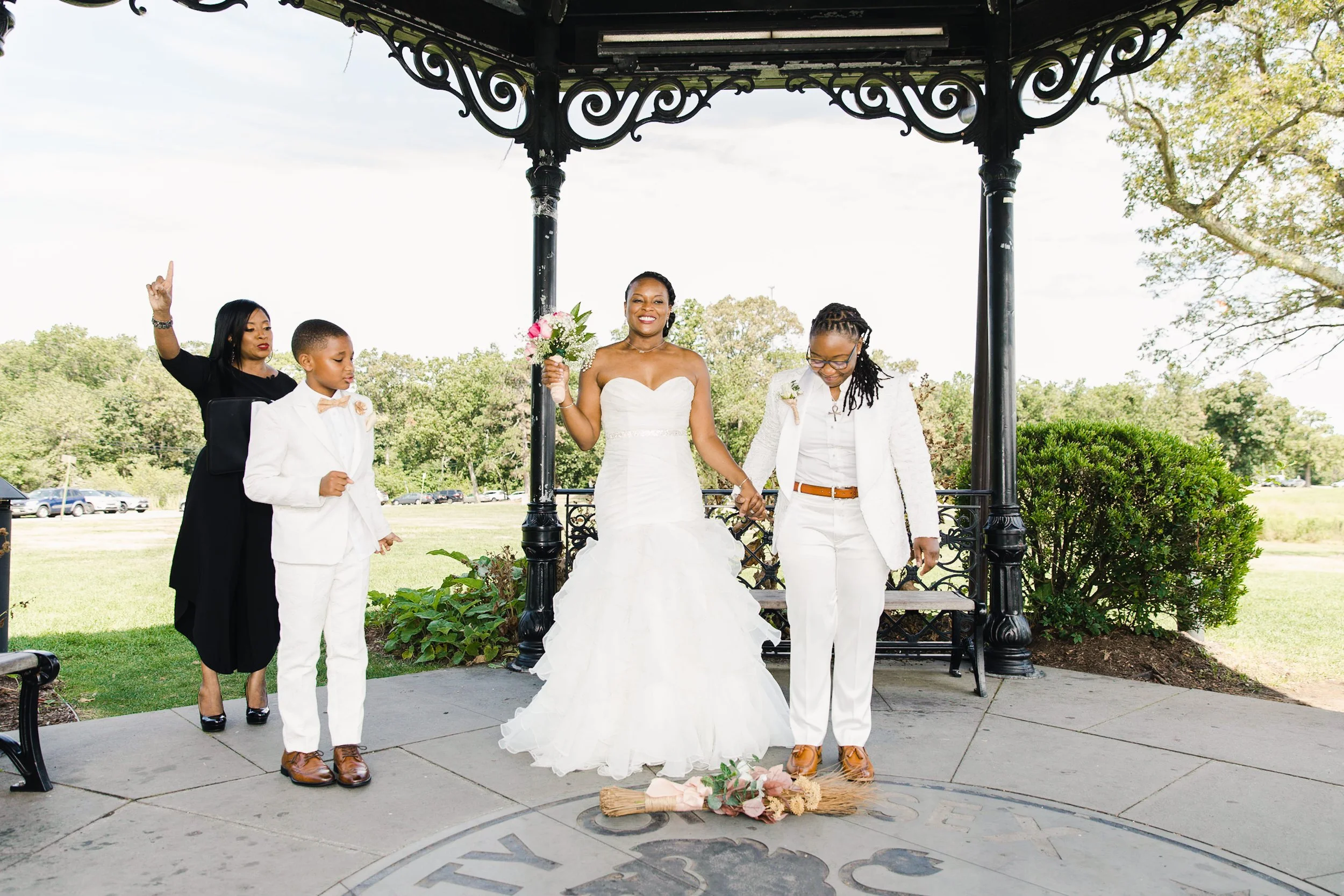 Luciana and Tevonda preparing to jump the broom with Tevonda’s son during their elopement ceremony at Eagle Rock Reservation.