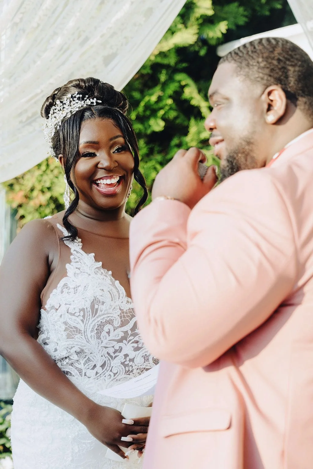 Kristie smiling at Gillon during an emotional moment at their Sand Castle wedding ceremony in Franklin Square, NY