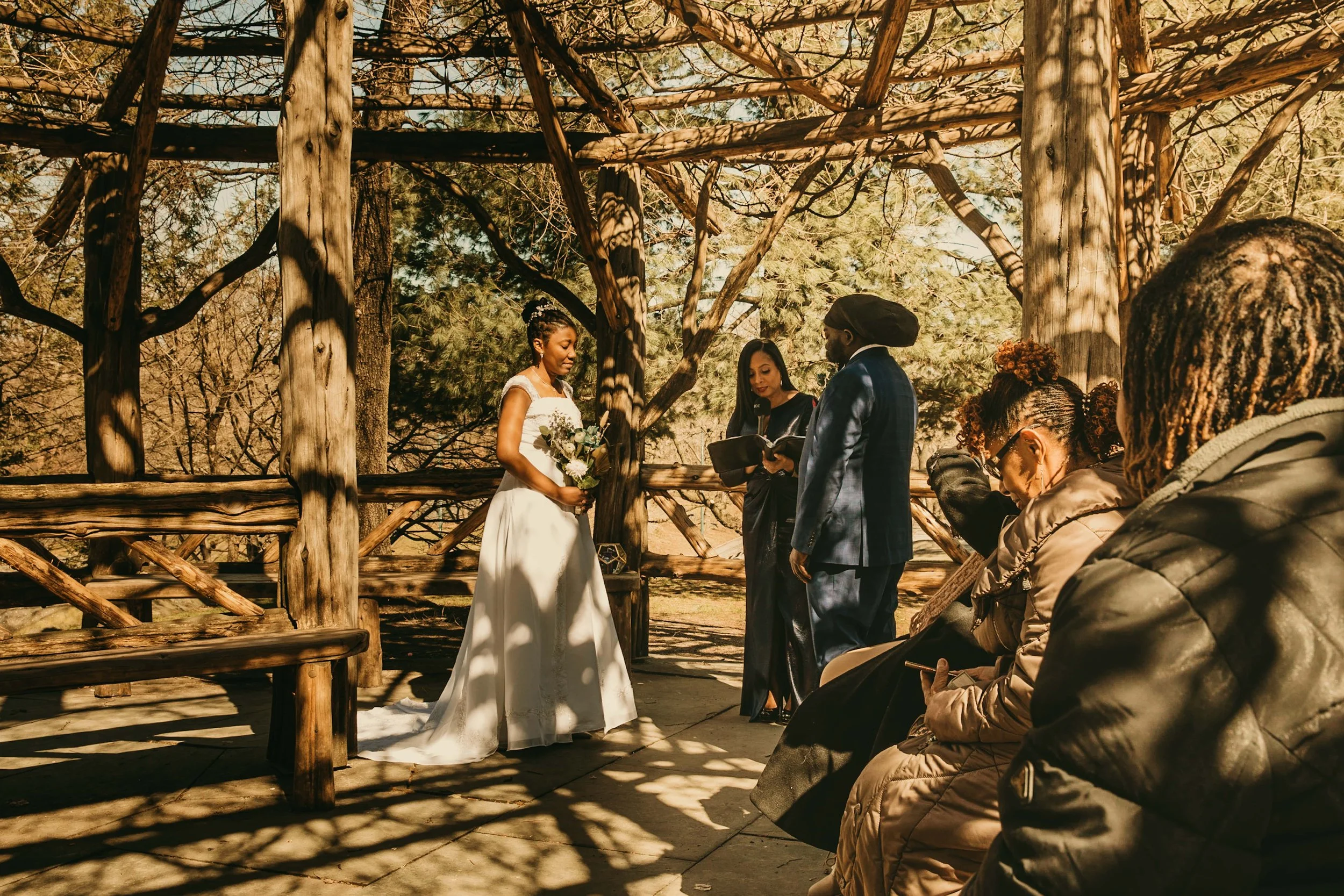 Bride and Groom with Wedding Officiant and Guests in Central Park.jpg