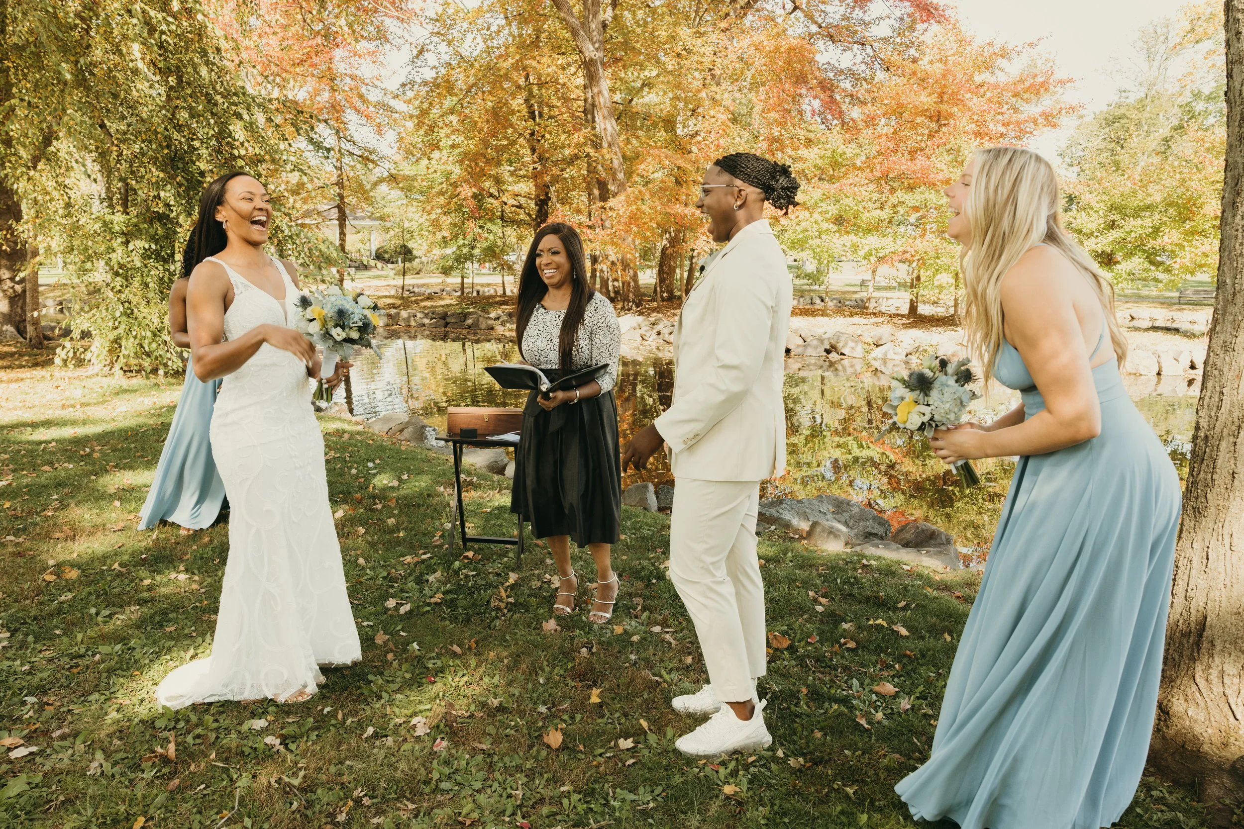 Couple laughing with their wedding officiant and best friend during their intimate elopement at Mindowaskin Park in Westfield, NJ.