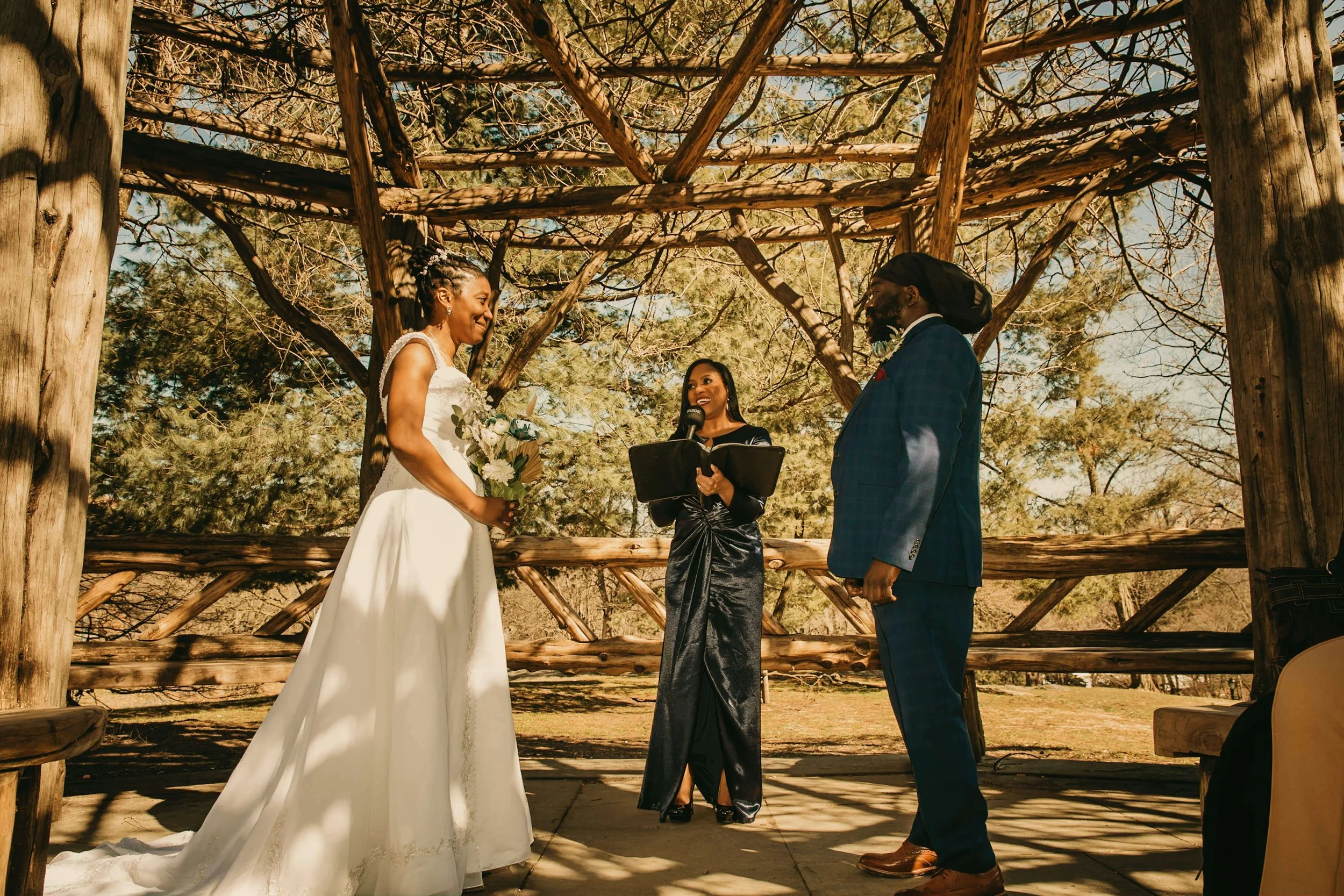 Bride and Groom with Wedding Officiant in Cop Cot Central Park New York City.jpg