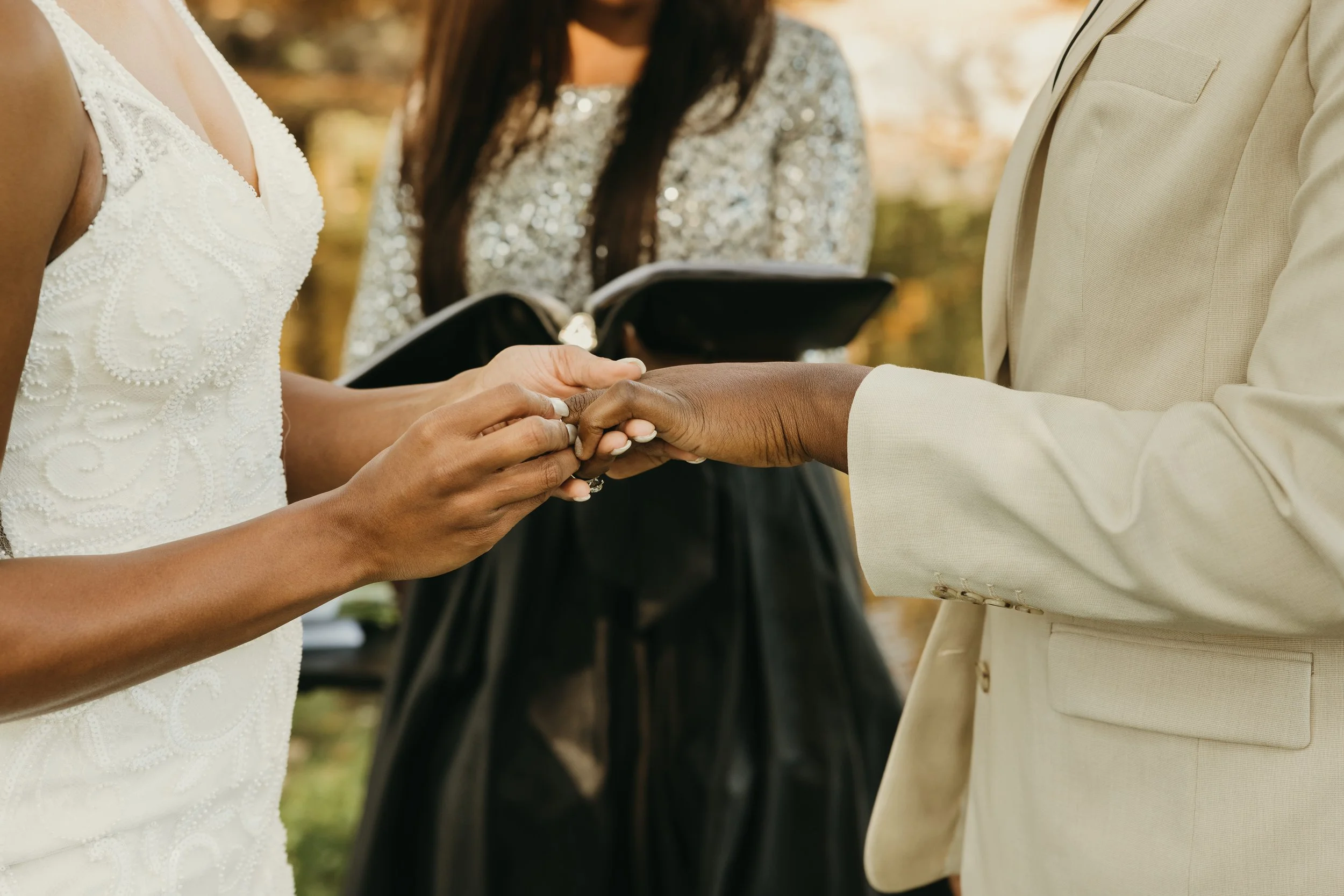 Jaide and Amiaya exchange wedding rings during their intimate elopement ceremony at Mindowaskin Park in Westfield, NJ.