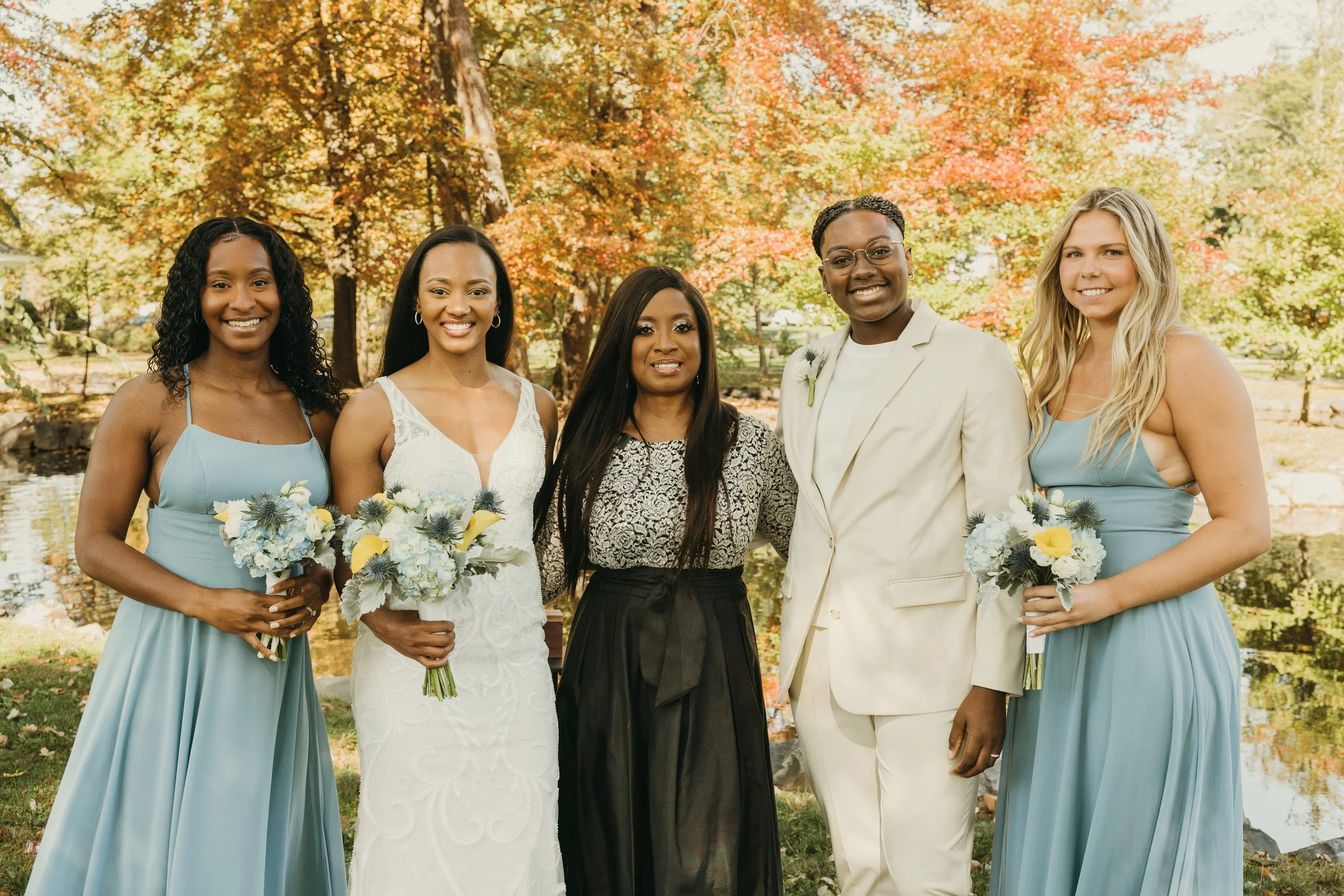 Jaide and Amiaya with their wedding officiant and two friends after their outdoor New Jersey elopement ceremony.