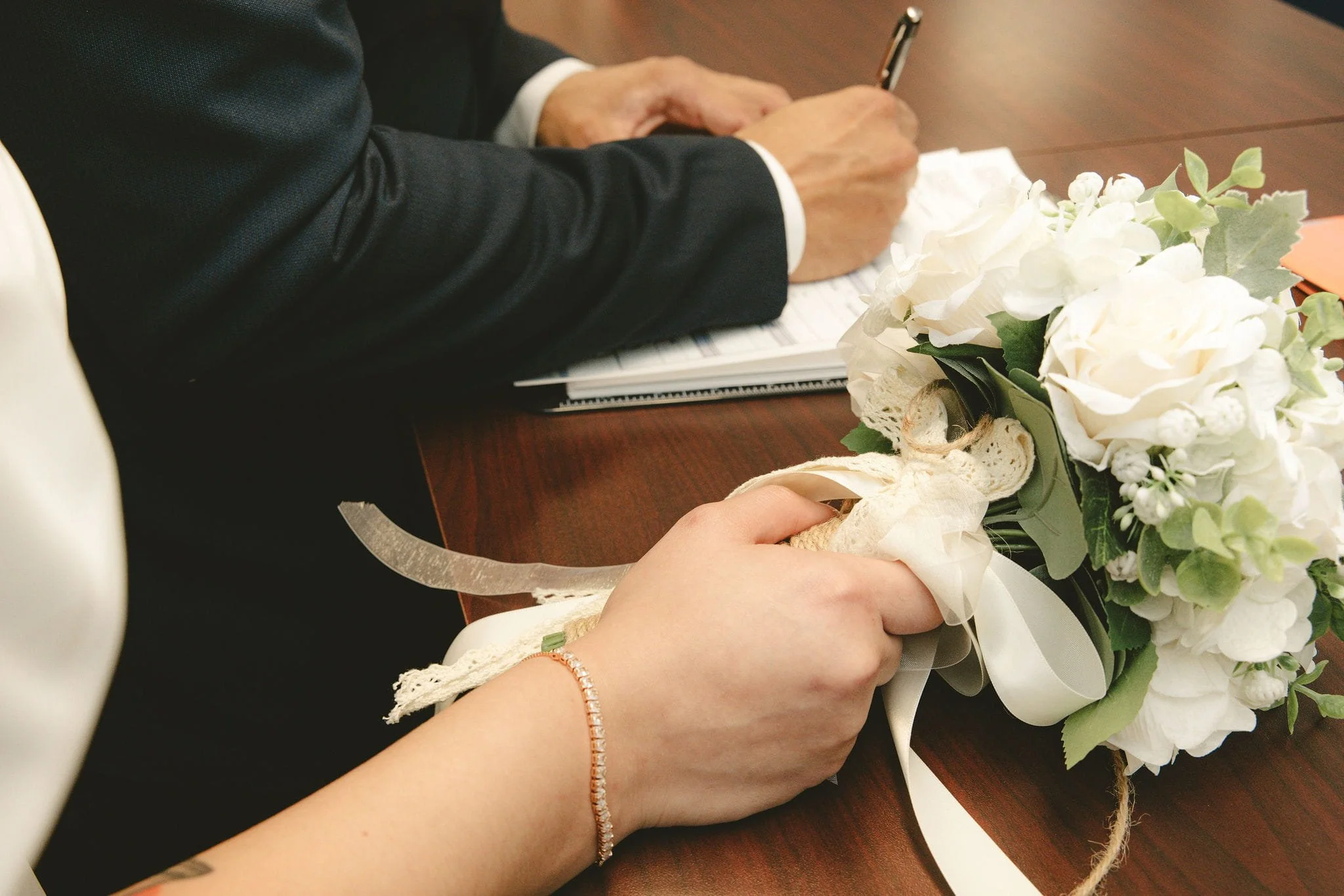 Newly married couple completing marriage certificate paperwork in Westfield, New Jersey.