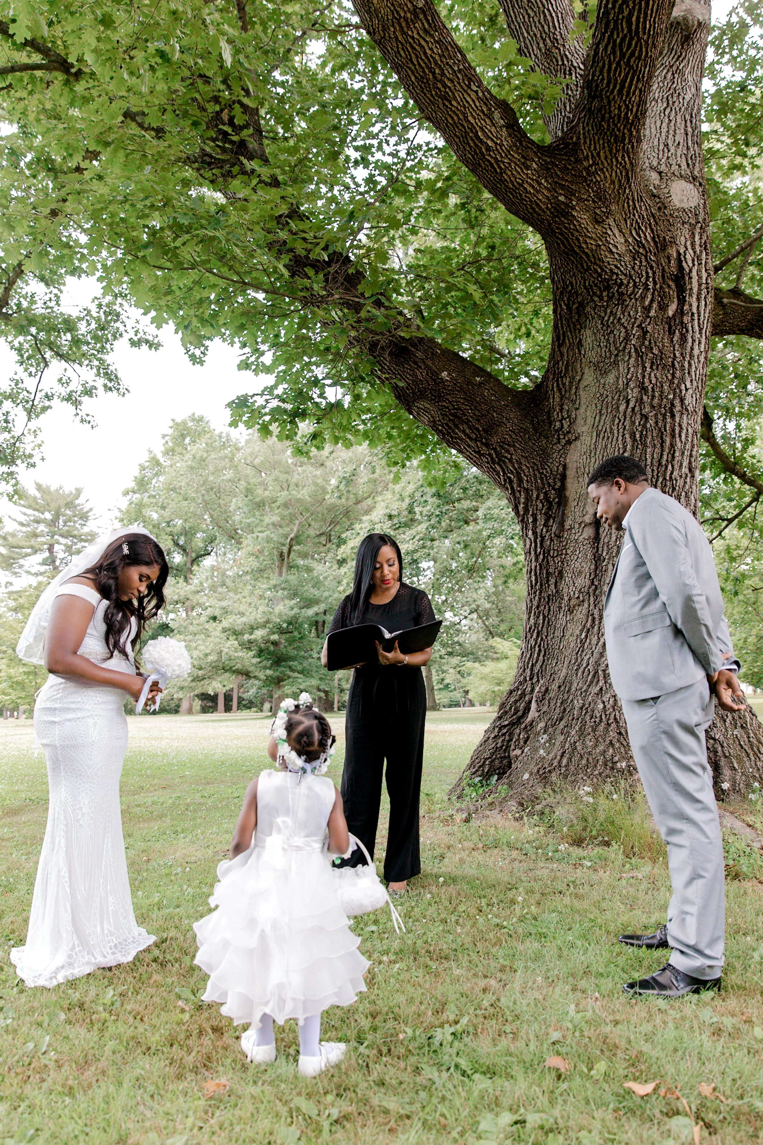 Intimate Morris County elopement ceremony officiated outdoors in New Jersey beneath a large tree