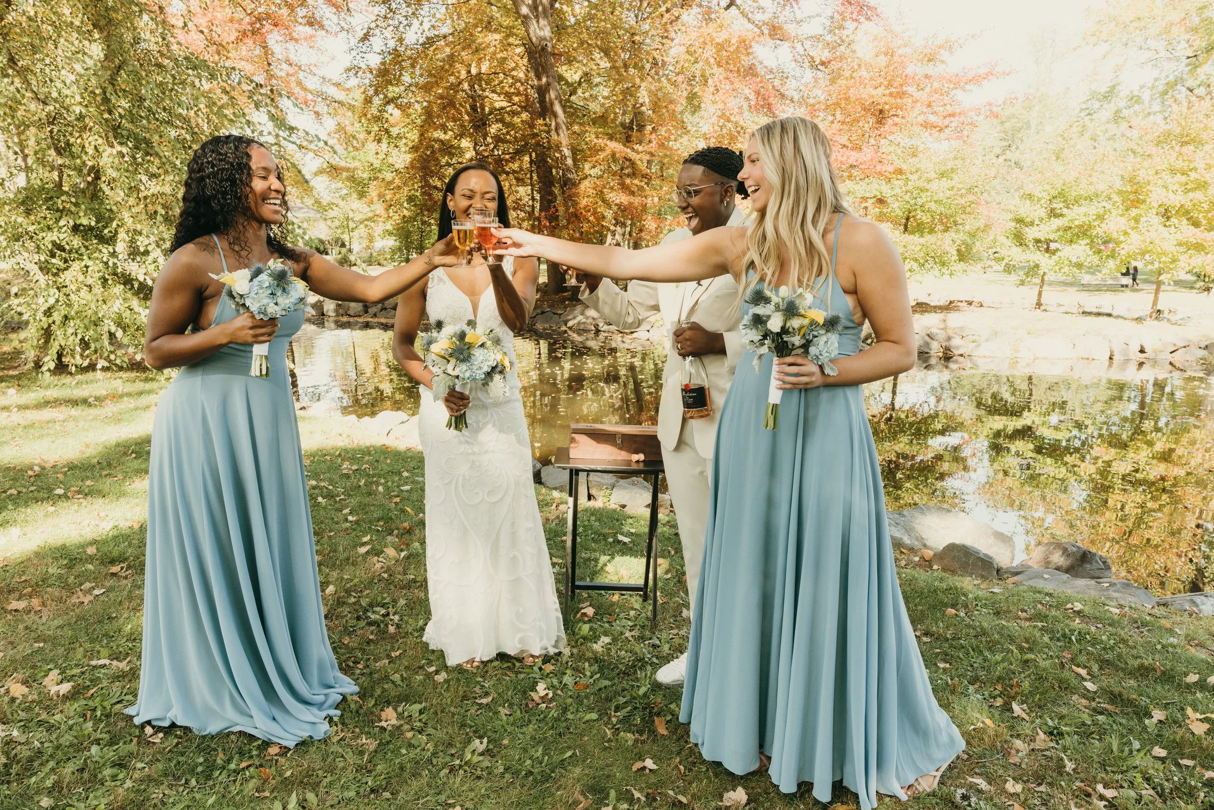 Jaide and Amiaya toast with their wedding party during their fall wedding ceremony at Mindowaskin Park in Westfield, NJ.
