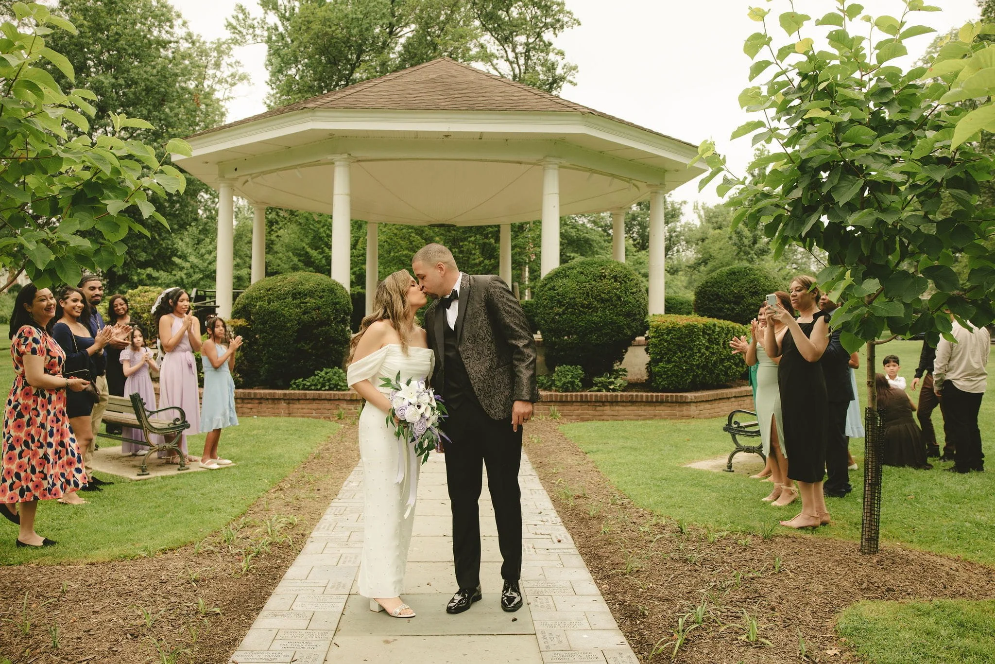 Newly married couple celebrating with family and friends after their elopement ceremony at Mindowaskin Park in Westfield, New Jersey.