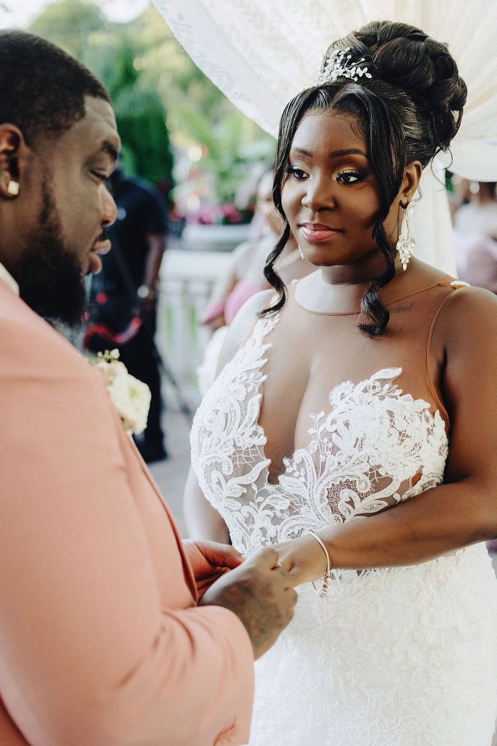 Kristie and Gillon exchanging rings during their wedding ceremony at Sand Castle in Franklin Square, NY