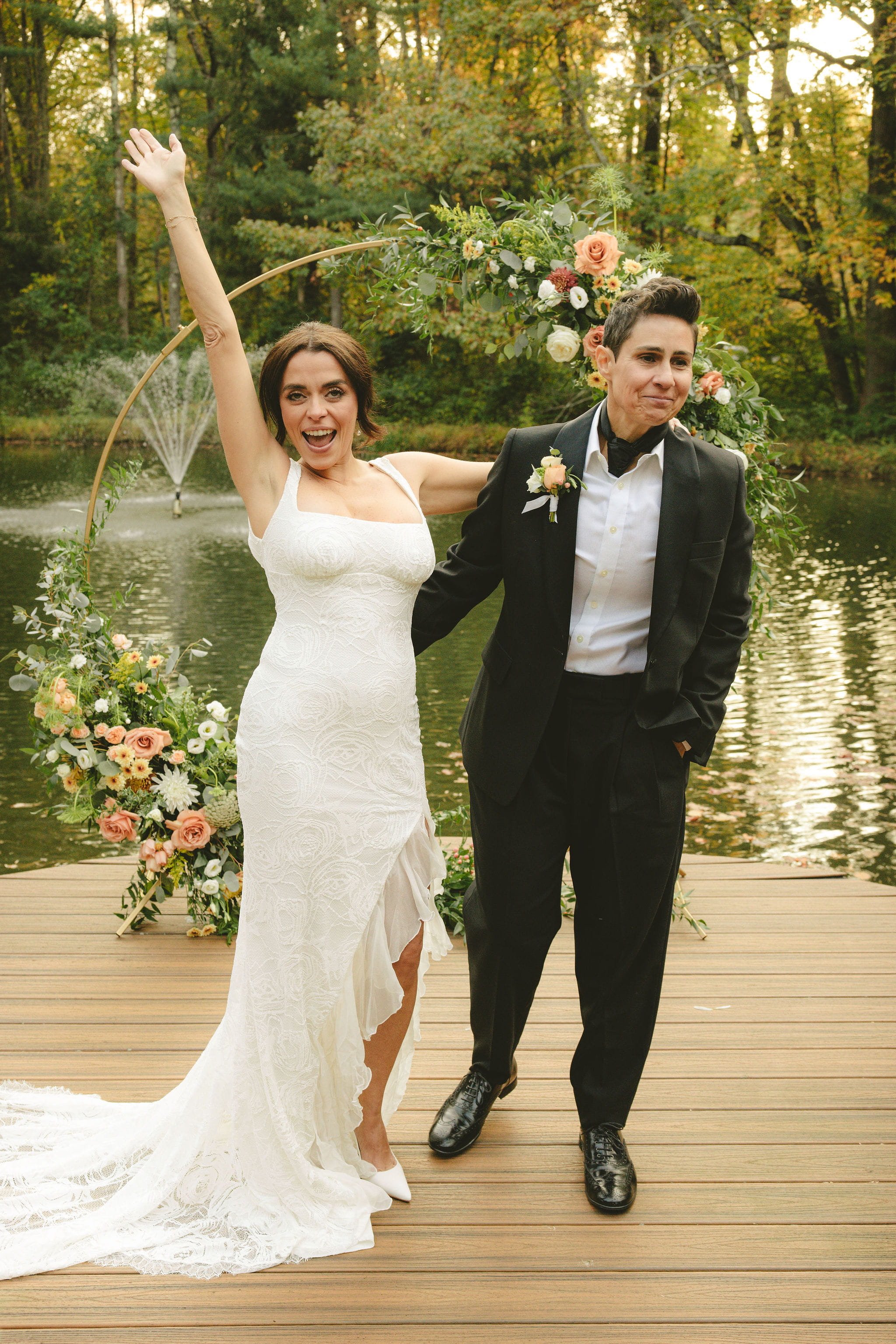 LGBTQ+ newlywed couple celebrating after their intimate lakeside elopement ceremony at a private location in Bernardsville, New Jersey.