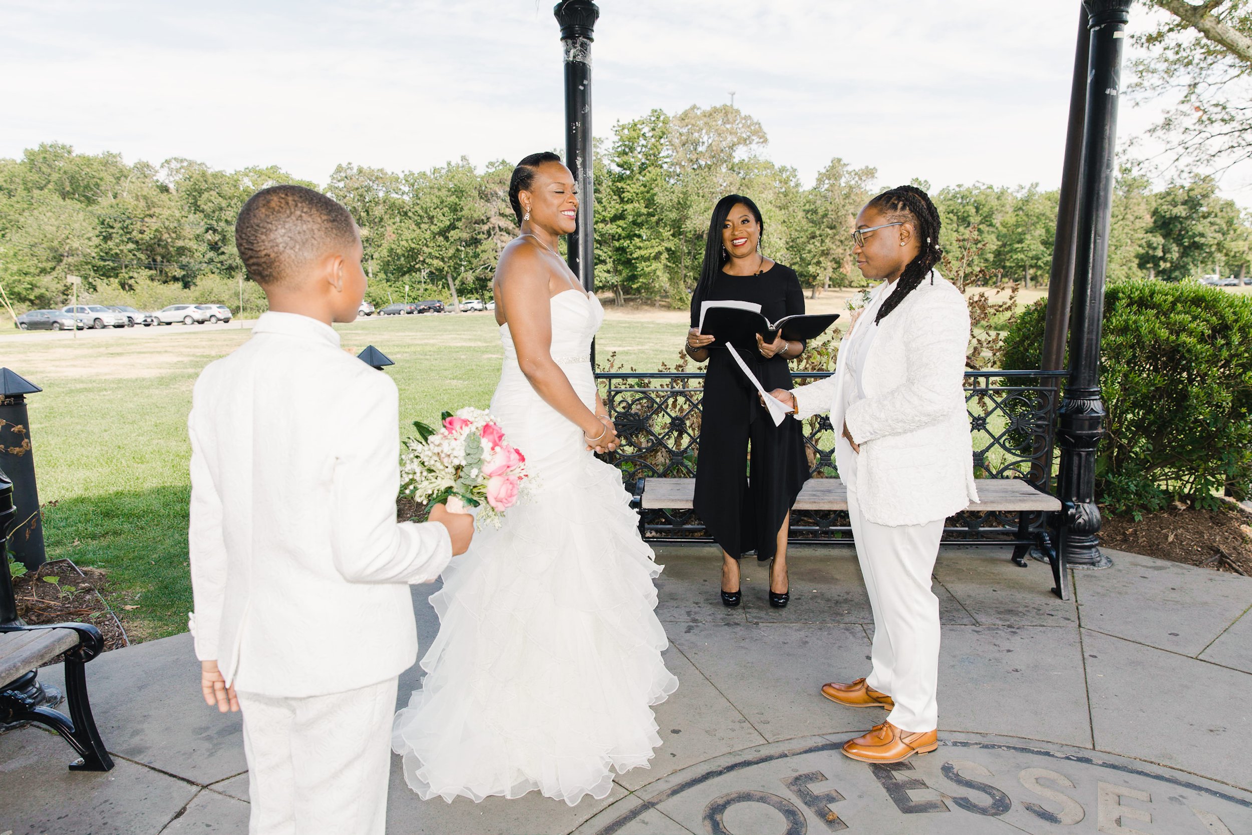 Wedding officiant Aretha performing Luciana and Tevonda’s New Jersey elopement ceremony with Tevonda’s son by their side.