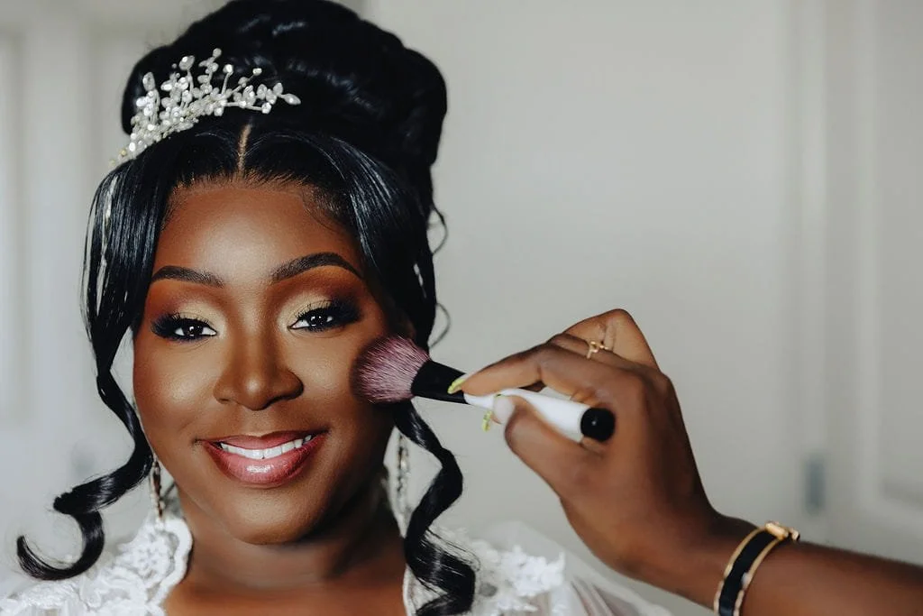 Kristie has the finishing touches applied to her makeup while getting ready for her wedding.