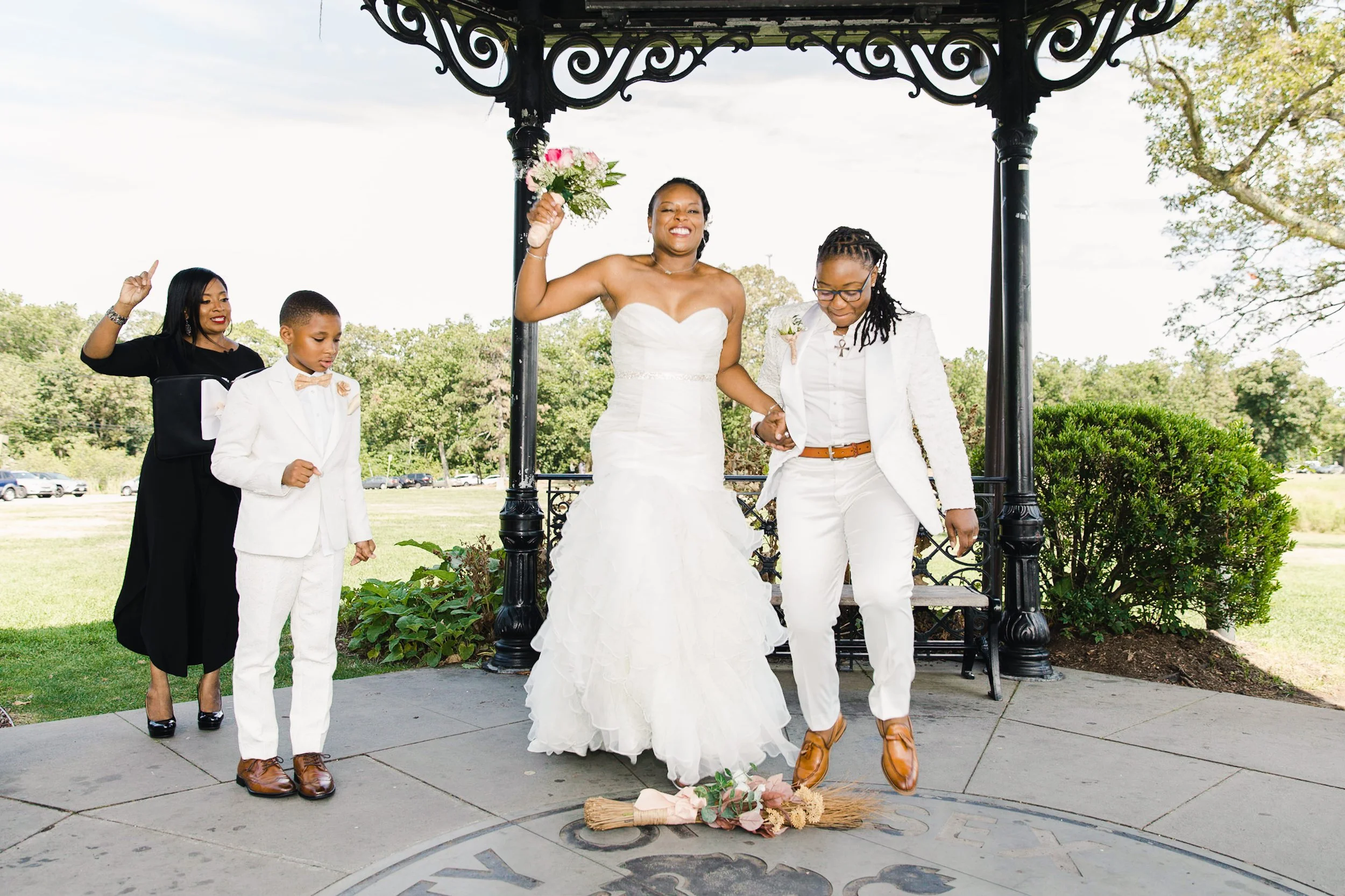 Luciana and Tevonda preparing to jump the broom with Tevonda’s son during their elopement ceremony at Eagle Rock Reservation.