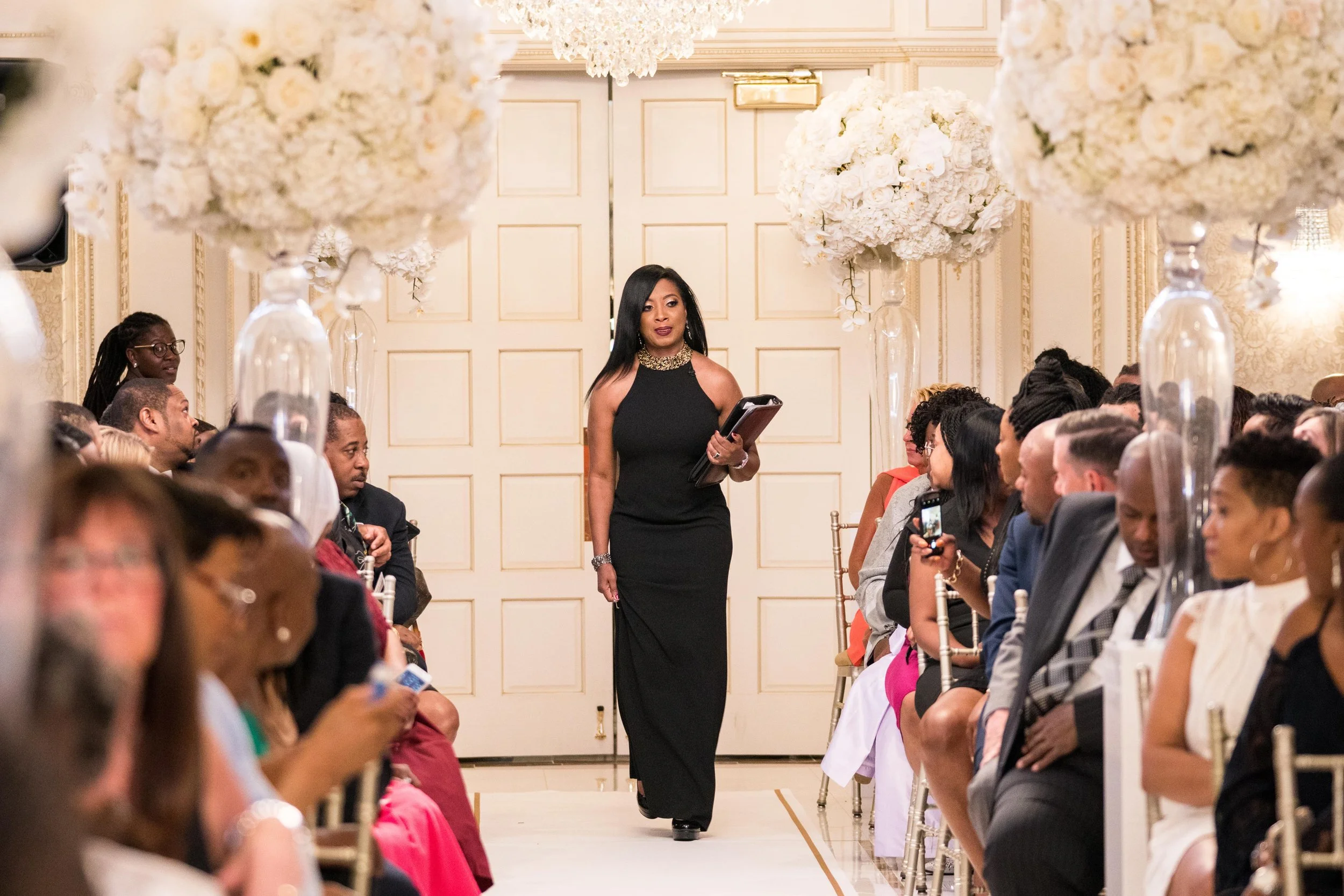 Wedding officiant walking down the aisle during a luxury ceremony at The Venetian in Garfield, New Jersey