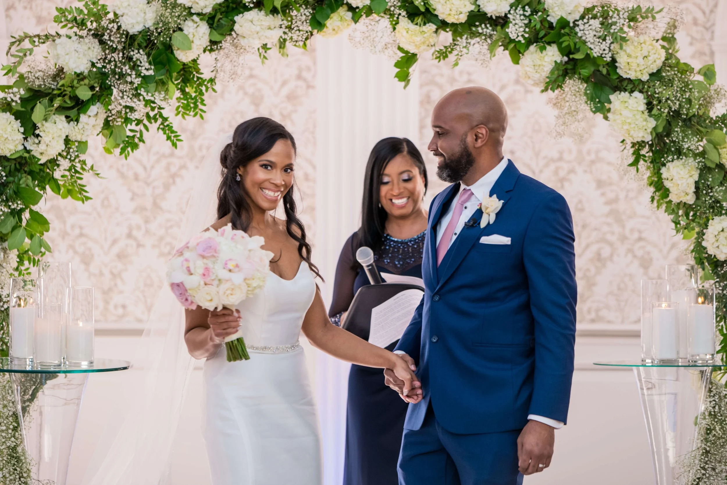 Newly married couple with wedding officiant Aretha Gaskin following their New Jersey ceremony