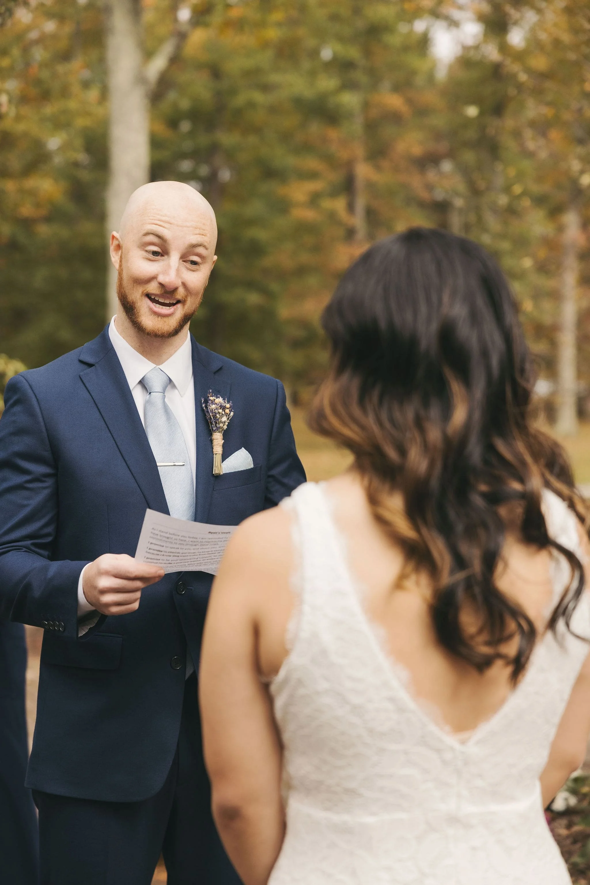 Groom reading personal vows during a private elopement ceremony in Hunterdon County, New Jersey