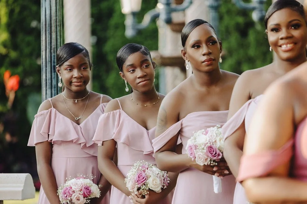 Members of Kristie’s bridal party holding pink and white bouquets at Sand Castle in Franklin Square, NY