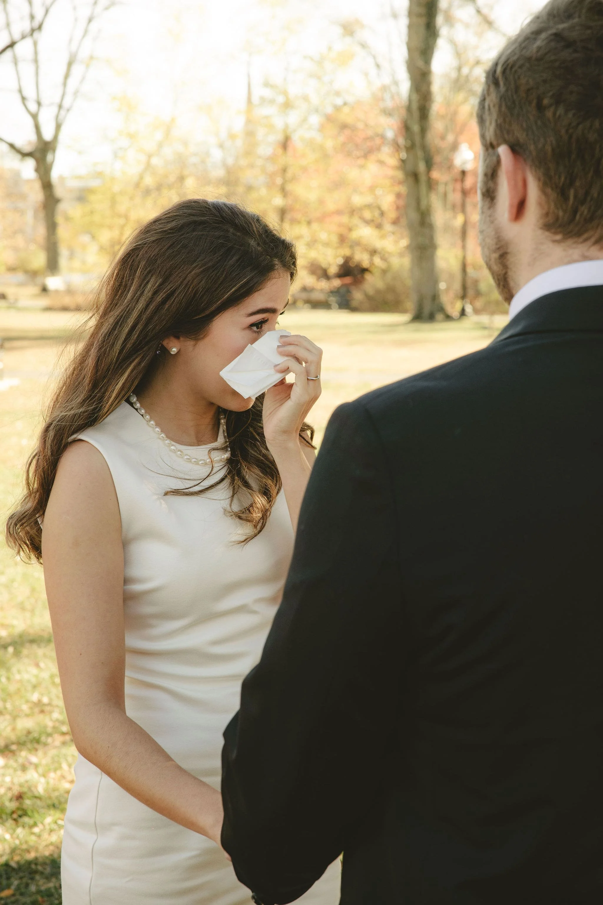 Bride wiping away tears during an intimate Monmouth County elopement ceremony officiated by Aretha Gaskin