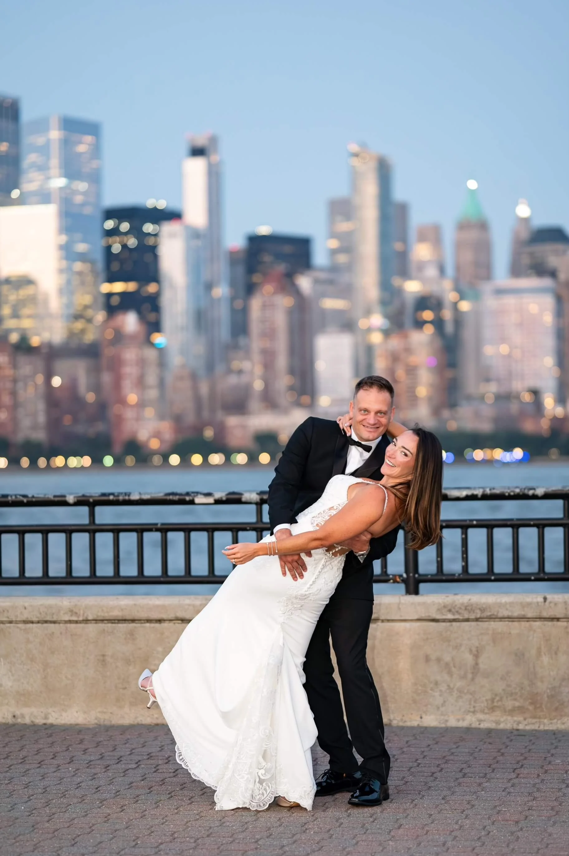 Couple celebrating their elopement at Liberty State Park in Hudson County, New Jersey with the New York City skyline in the background