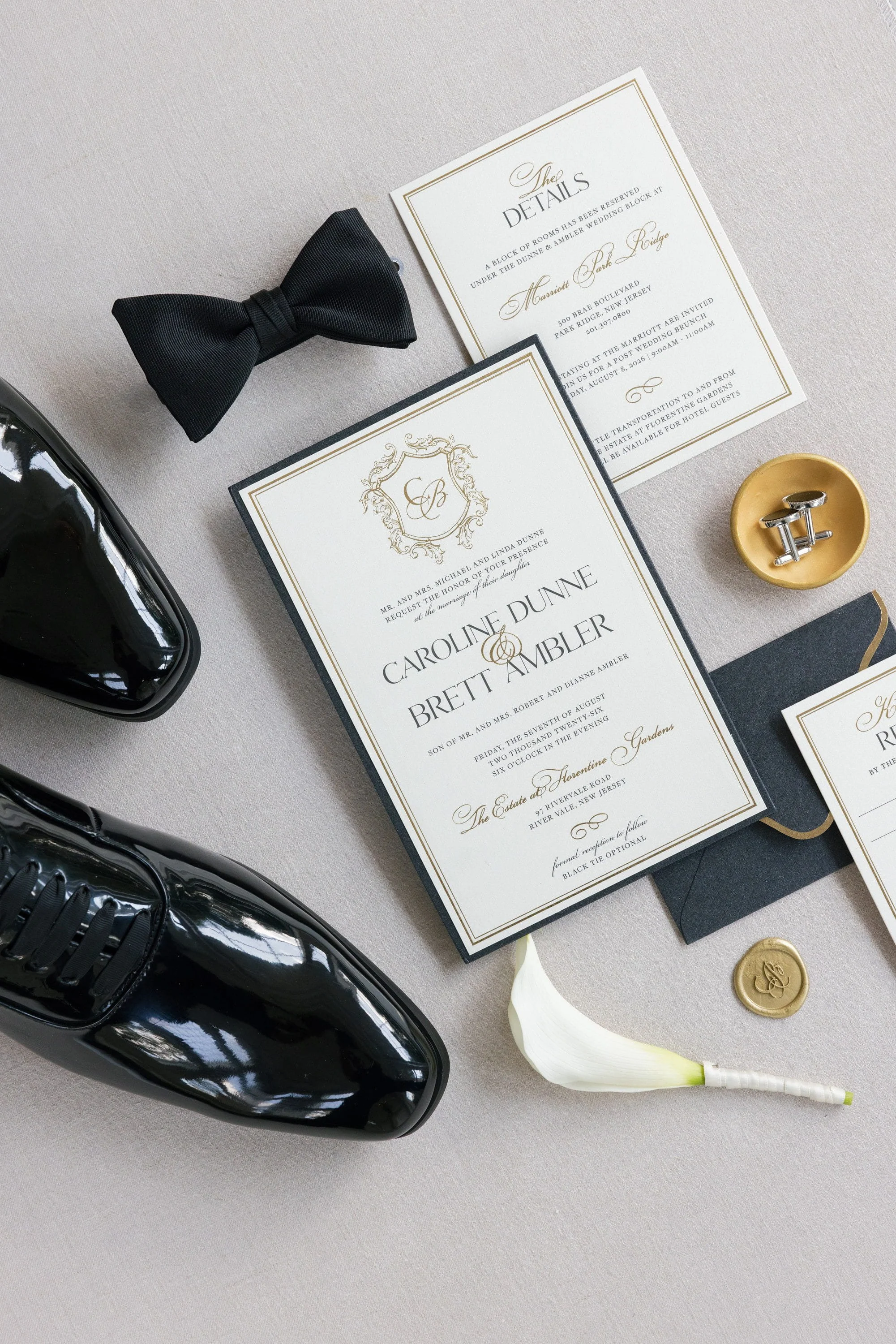 Caroline and Brett’s wedding shoes, rings, bow tie and stationery arranged together before the ceremony